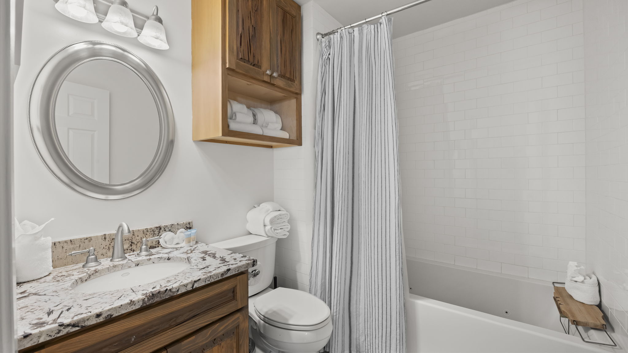 Guests can enjoy ultimate relaxation in the bathroom of our Cotton Bayou condo, featuring a luxurious Jacuzzi tub with air jets and continuous heat. Perfect for unwinding after a day of fun on the water or exploring the area.