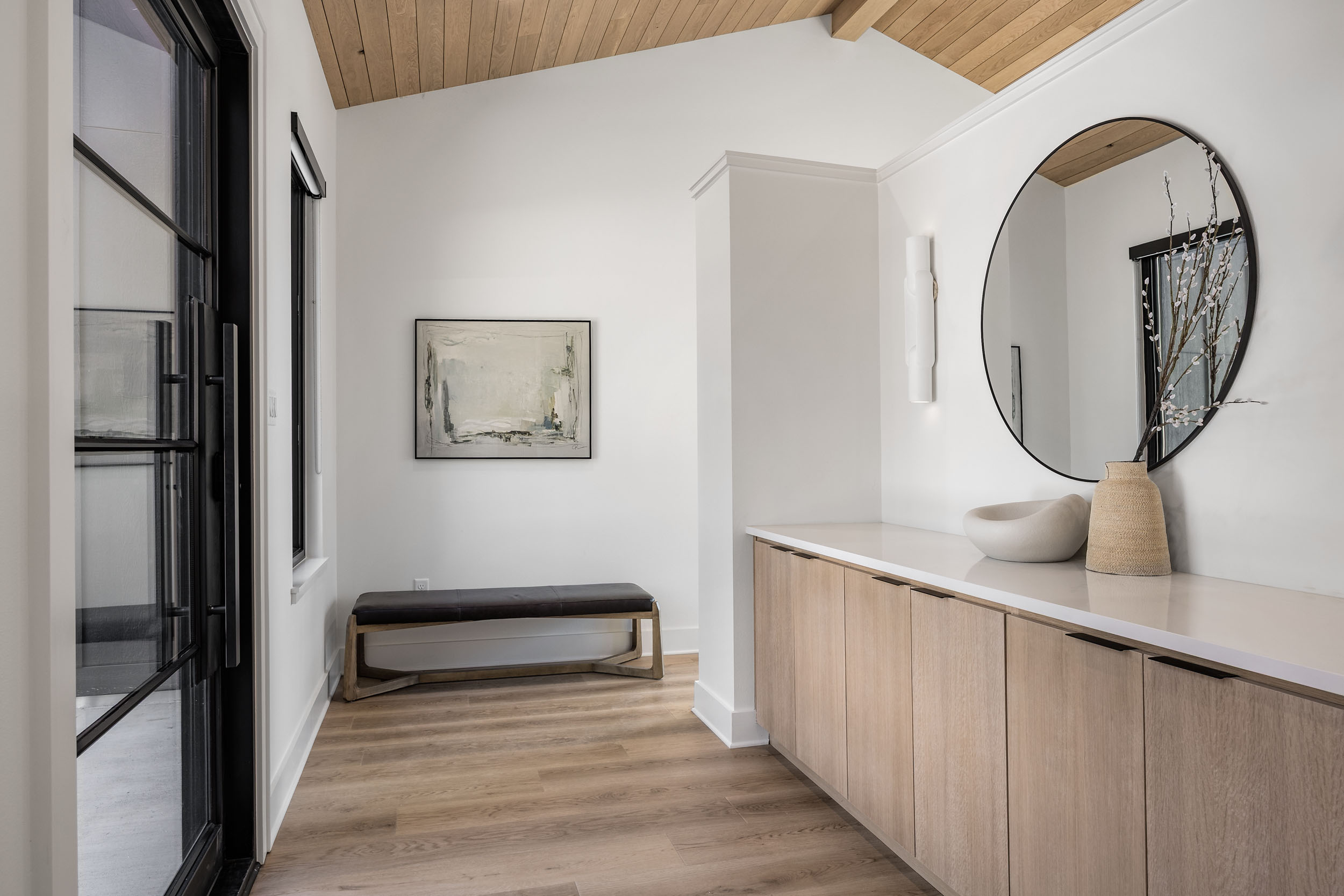 A warm, modern entryway that welcomes you in with calming tones and clean design.