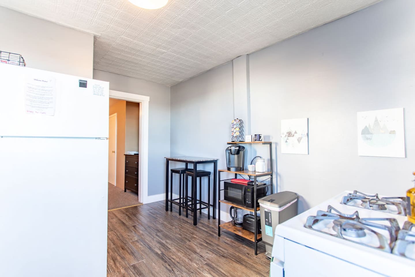 Kitchen with a bistro table for dining and a coffee bar.