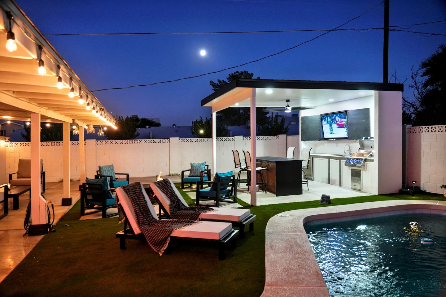Watch the game on the outdoor large 65” TV from the pool, or gather around the covered bar. The beautiful evening lights make this space perfect for relaxing after a day in the Arizona sun.