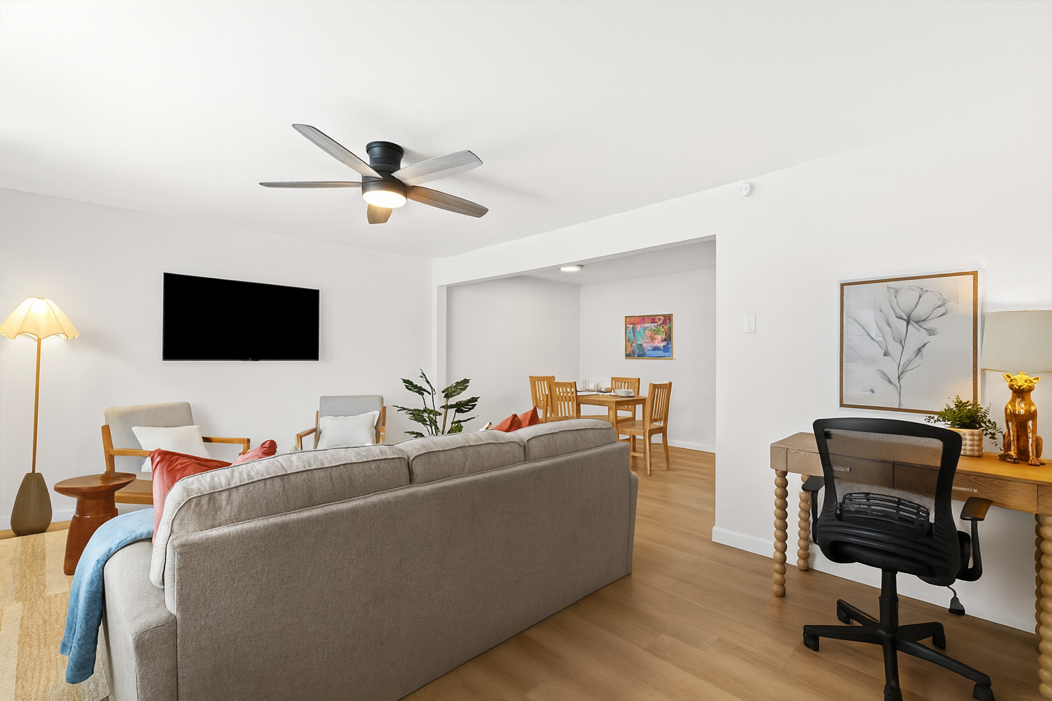The desk setup sits conveniently between the living and dining areas for easy access and seamless flow.