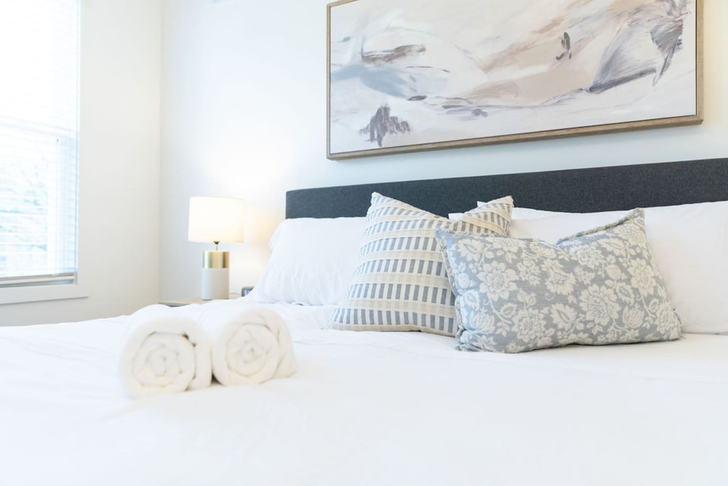 Zoomed-in view of the king-size bed with soft pillows, offering a cozy and inviting retreat.