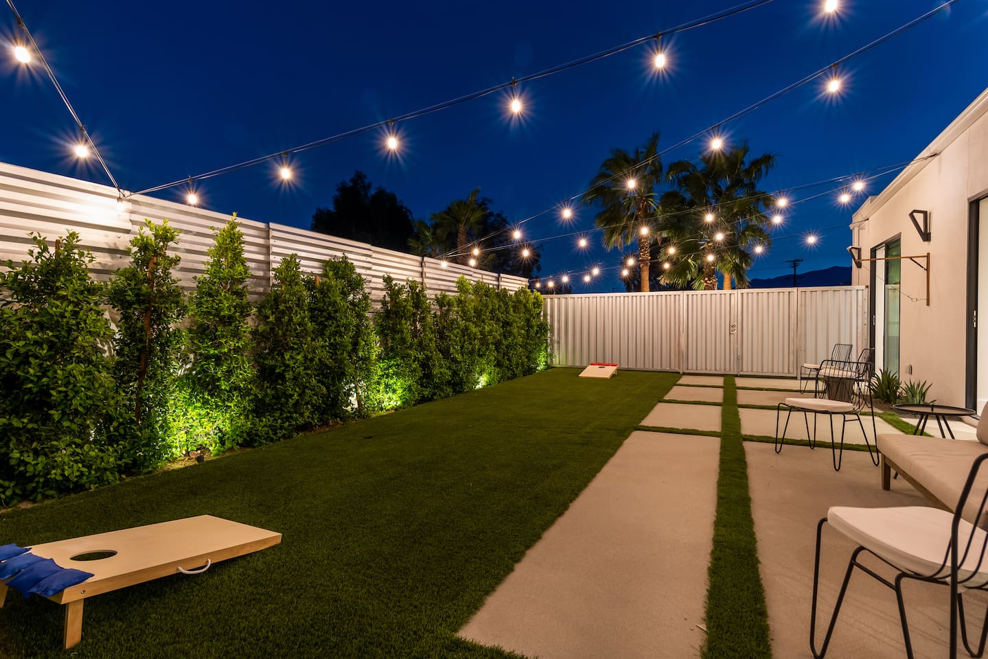 Outdoor game patio with string lighting for nighttime play