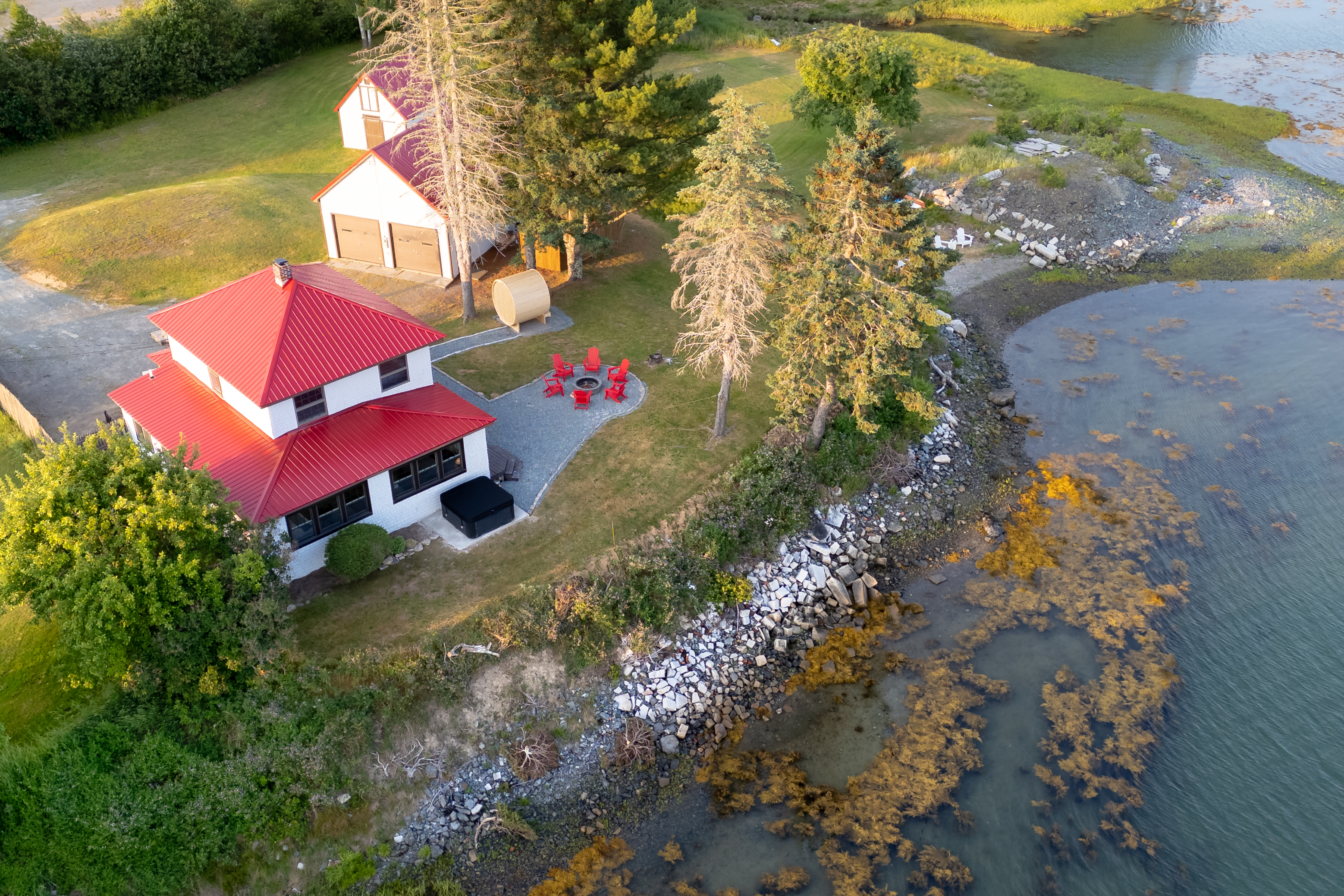 See your whole retreat from above — private peninsula on the tidal cove, water access on three sides, dock and beach right off the back lawn.