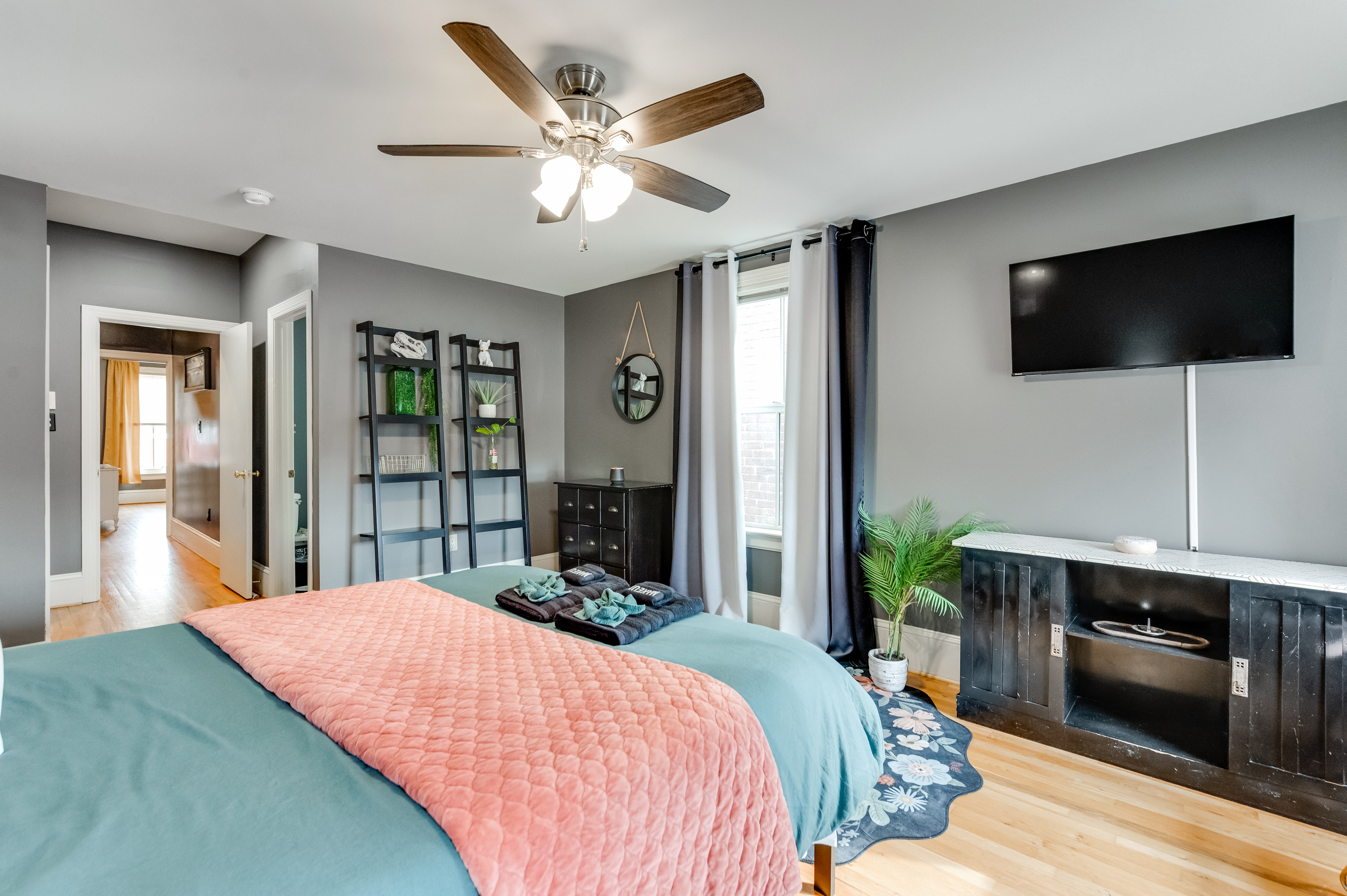 Queen Bedroom 3: Relax under the ceiling fan with modern decor and a large flat-screen TV!