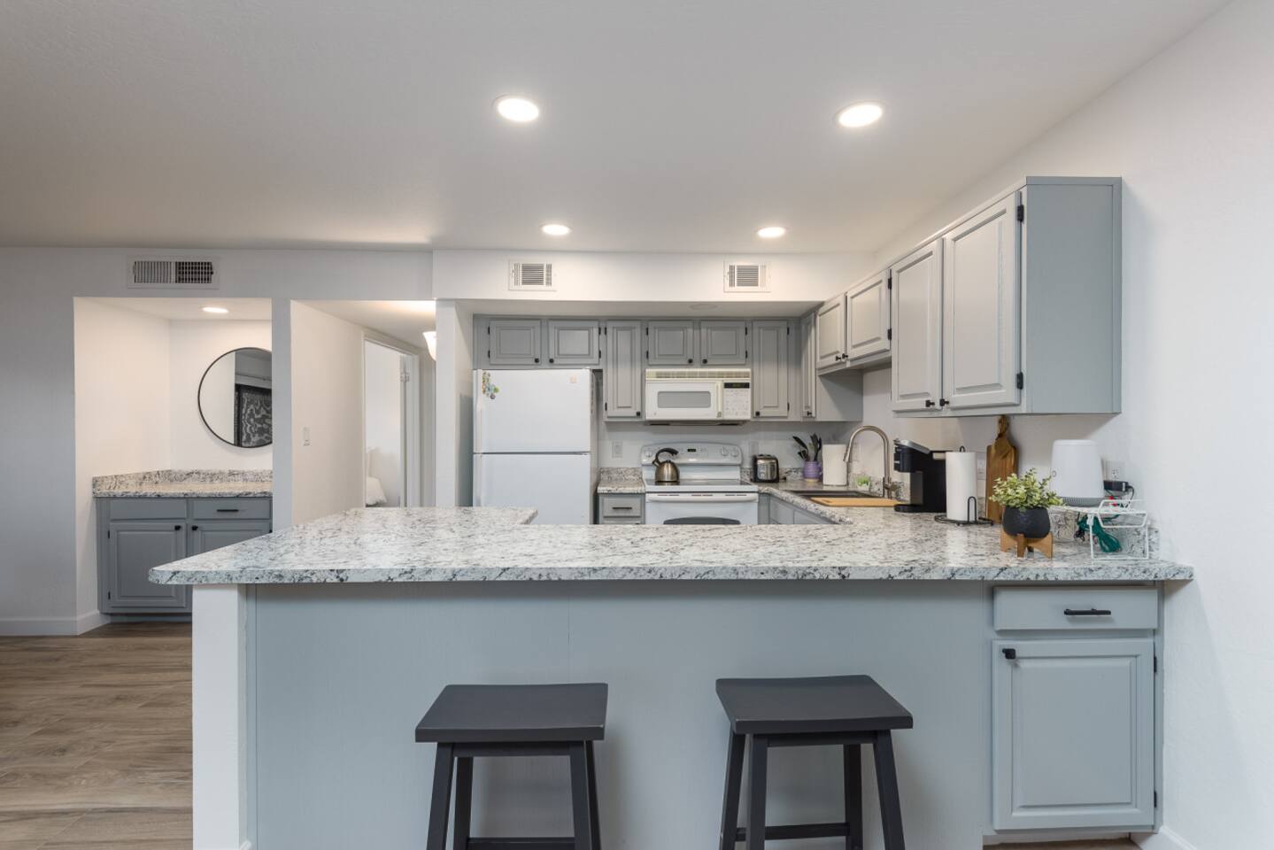Kitchen with bar seating, wide counters, and an easy view into the main living space.

