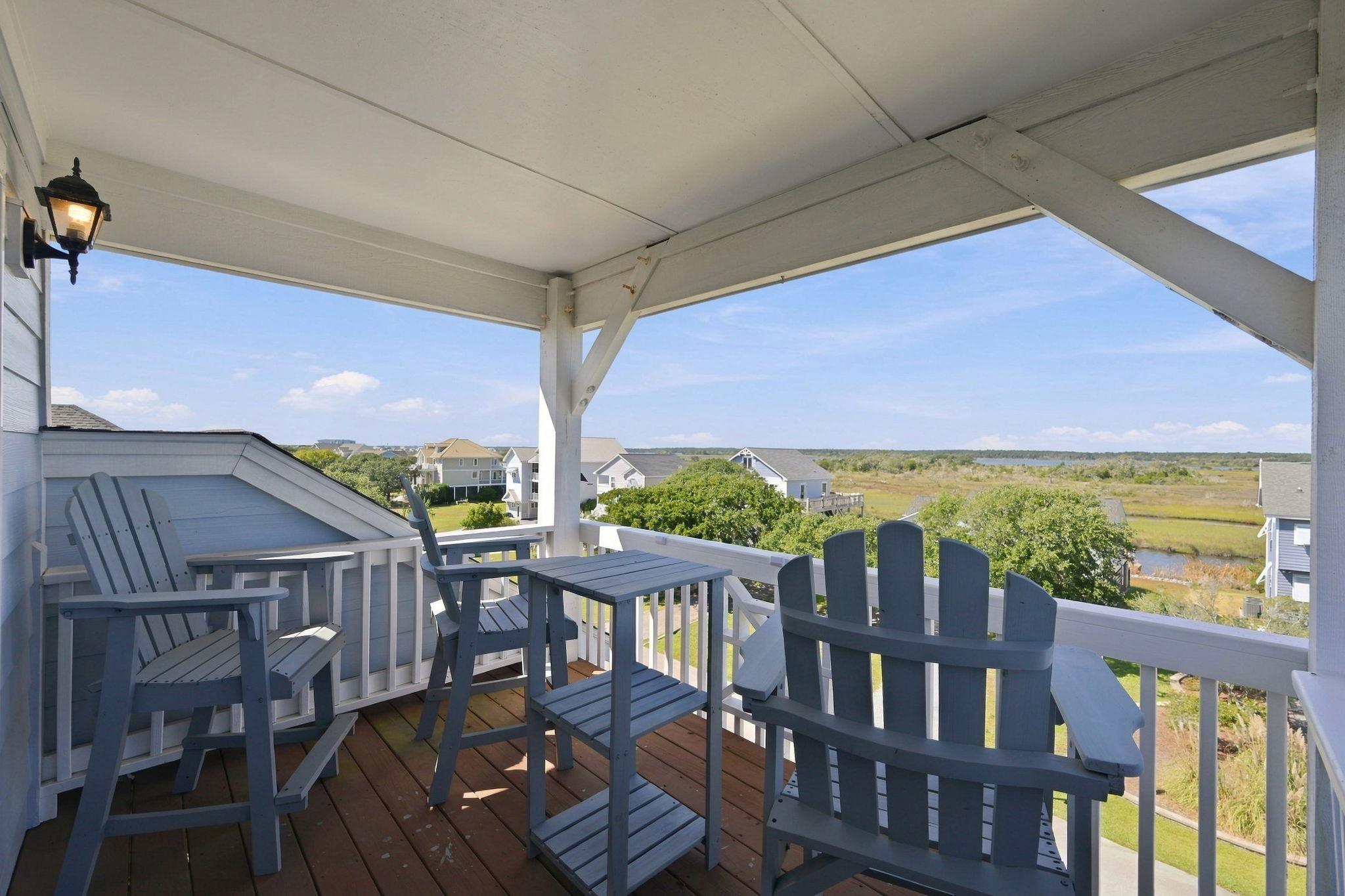 Take in beautiful marshland views from the covered balcony, complete with comfortable Adirondack seating