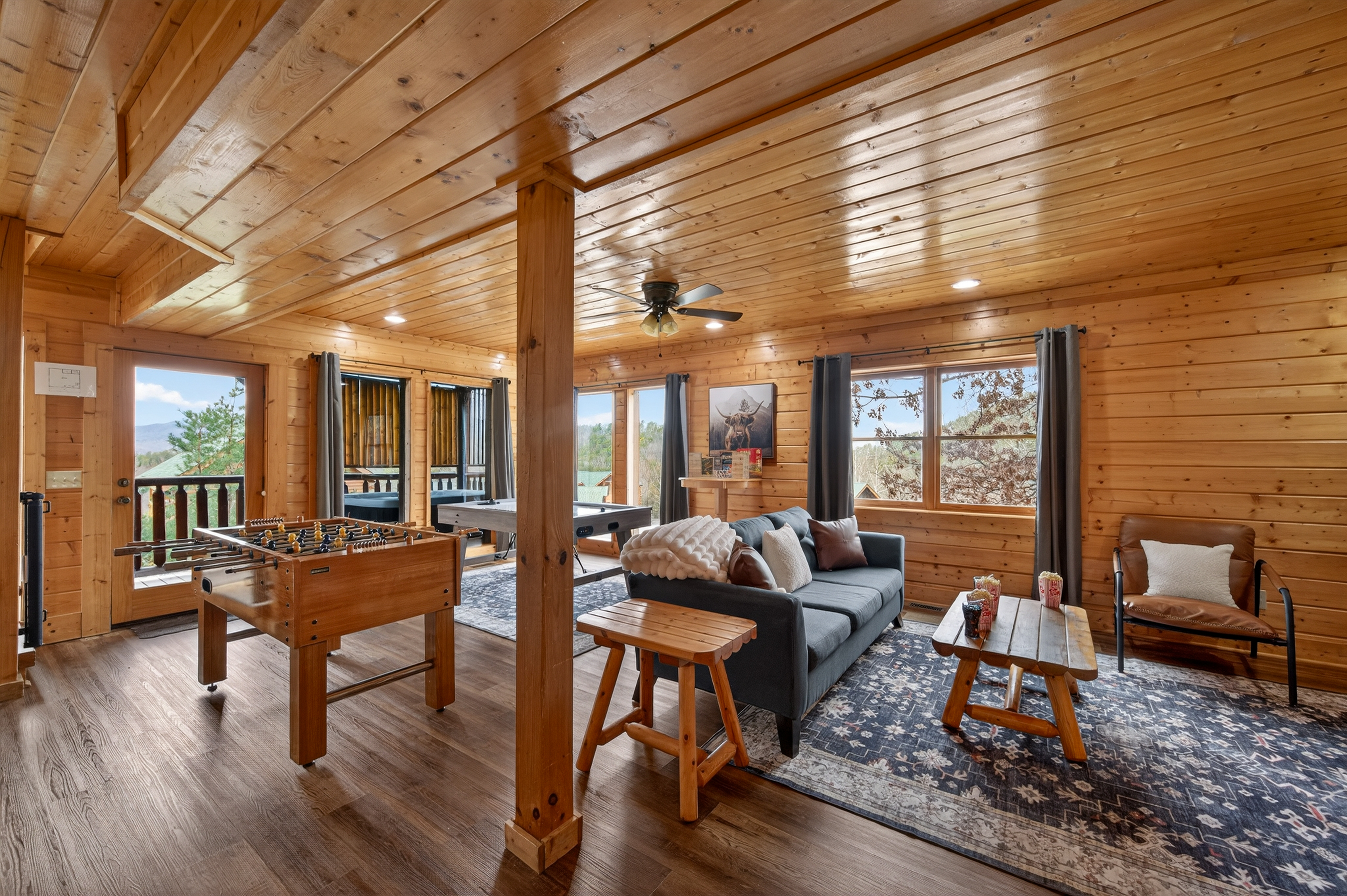 Air hockey, foosball, Smart TV, couch, board games — and the hot tub just through that door. The lower level game room is where the group ends up every night, whether anyone planned it or not.