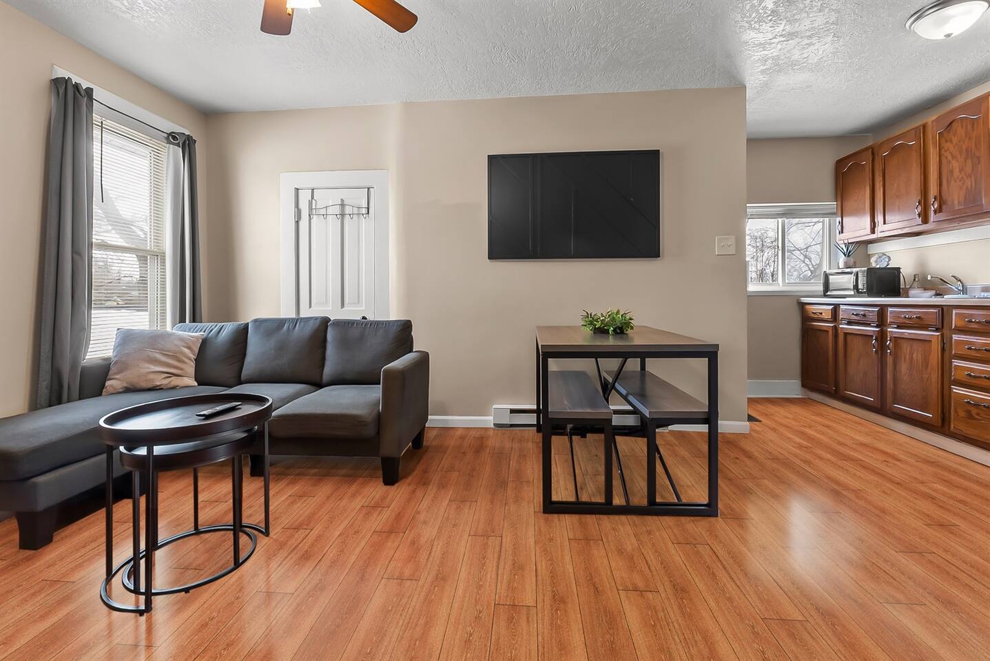 Cozy living space with a comfortable couch and center table, seamlessly flowing into the dining area for a perfect blend of relaxation and meals.