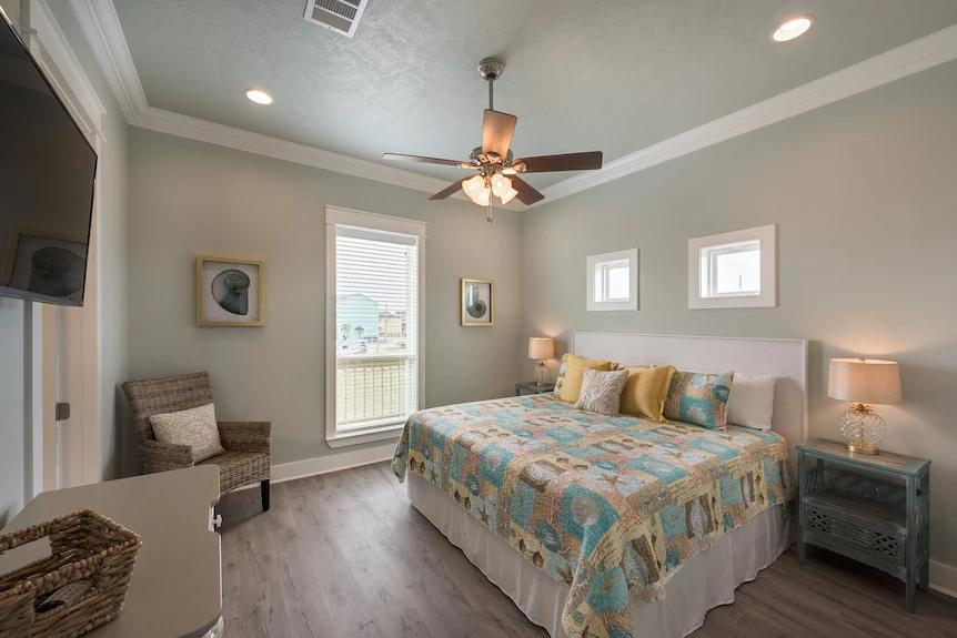 Breezy Point Primary First Floor Bedroom: Primary bedroom with a luxurious king-size bed, ample natural light, and an ensuite.