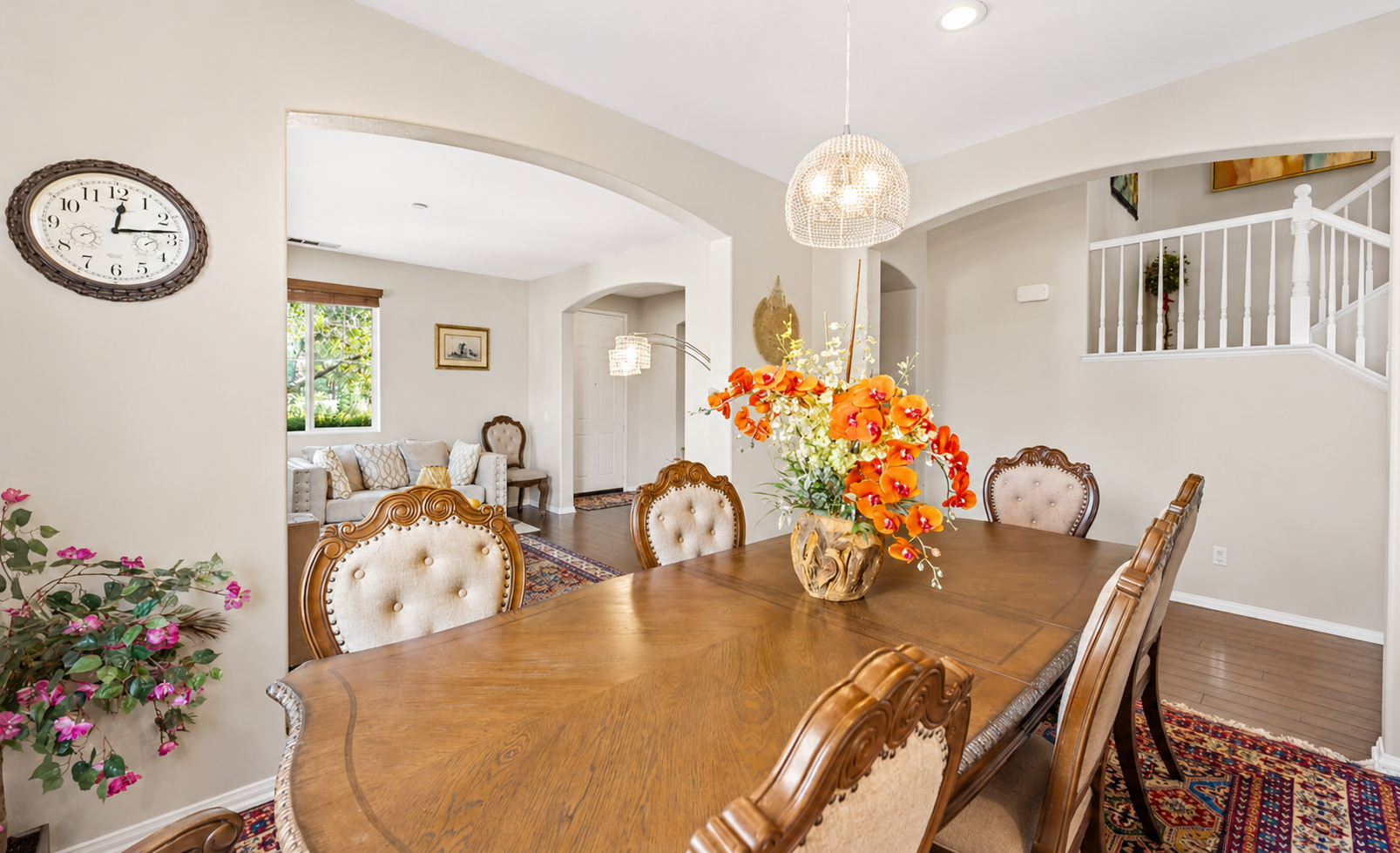 Dining room with a large table, warm wood details, and an easy view into the living room.