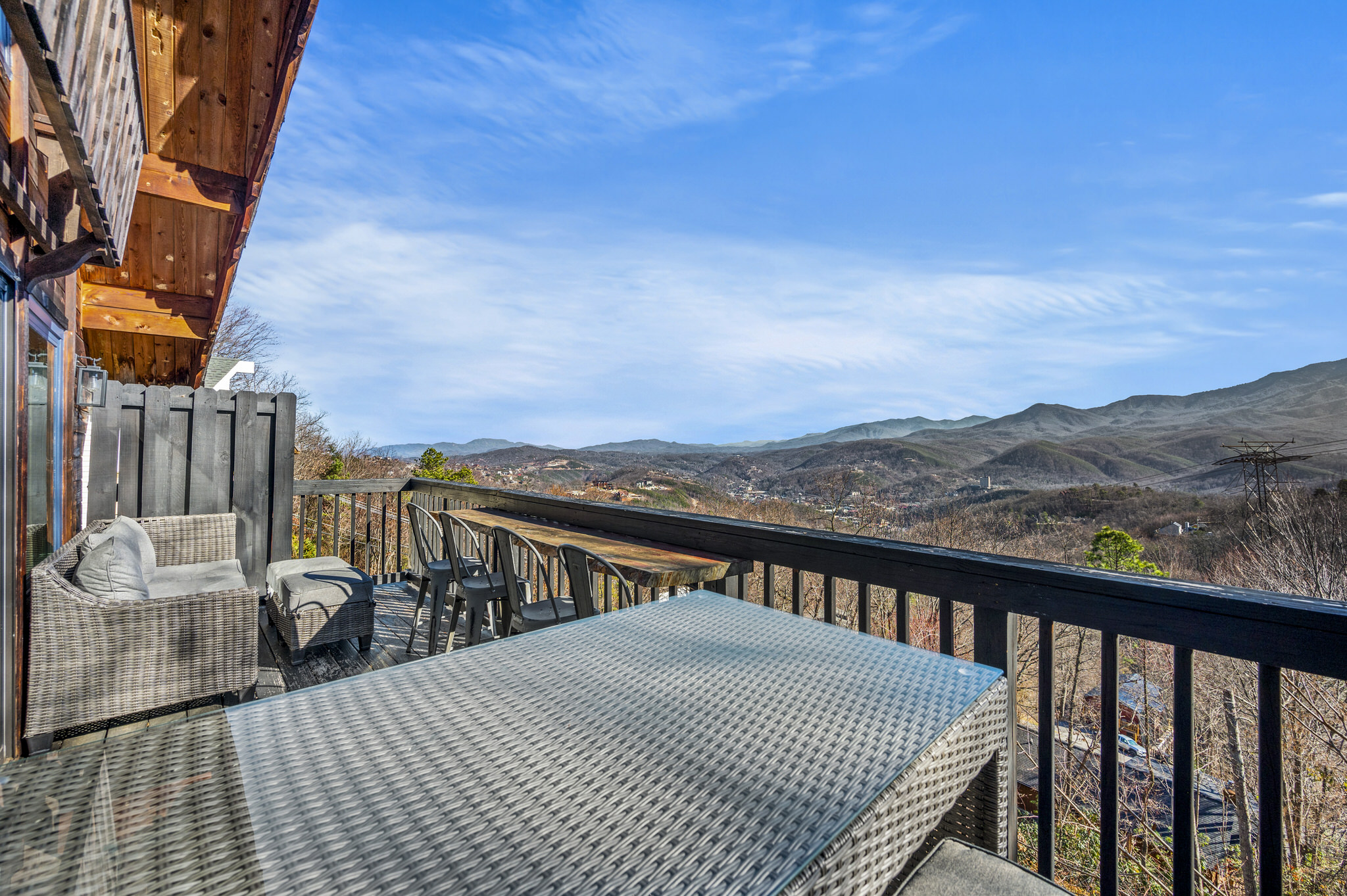 The main floor deck is spacious and features multiple seating options, plus bar height table.  Enjoy the epic long range views, Mount LeConte view and Gatlinburg view all while the Ober Gatlinburg tram makes its occasional appearance!