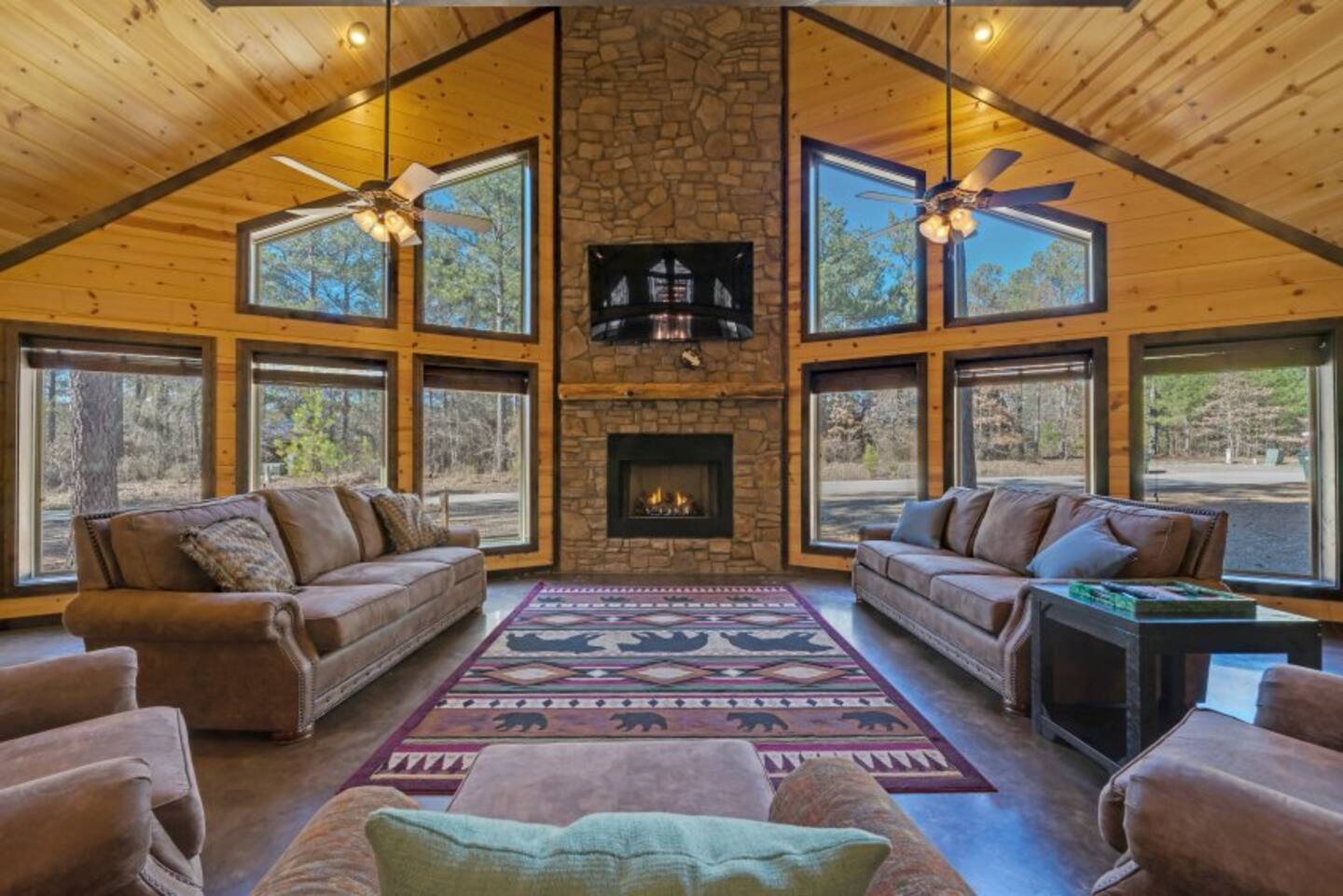 Sink into plush couches by the fireplace in this cozy Sweet Serenity living room.