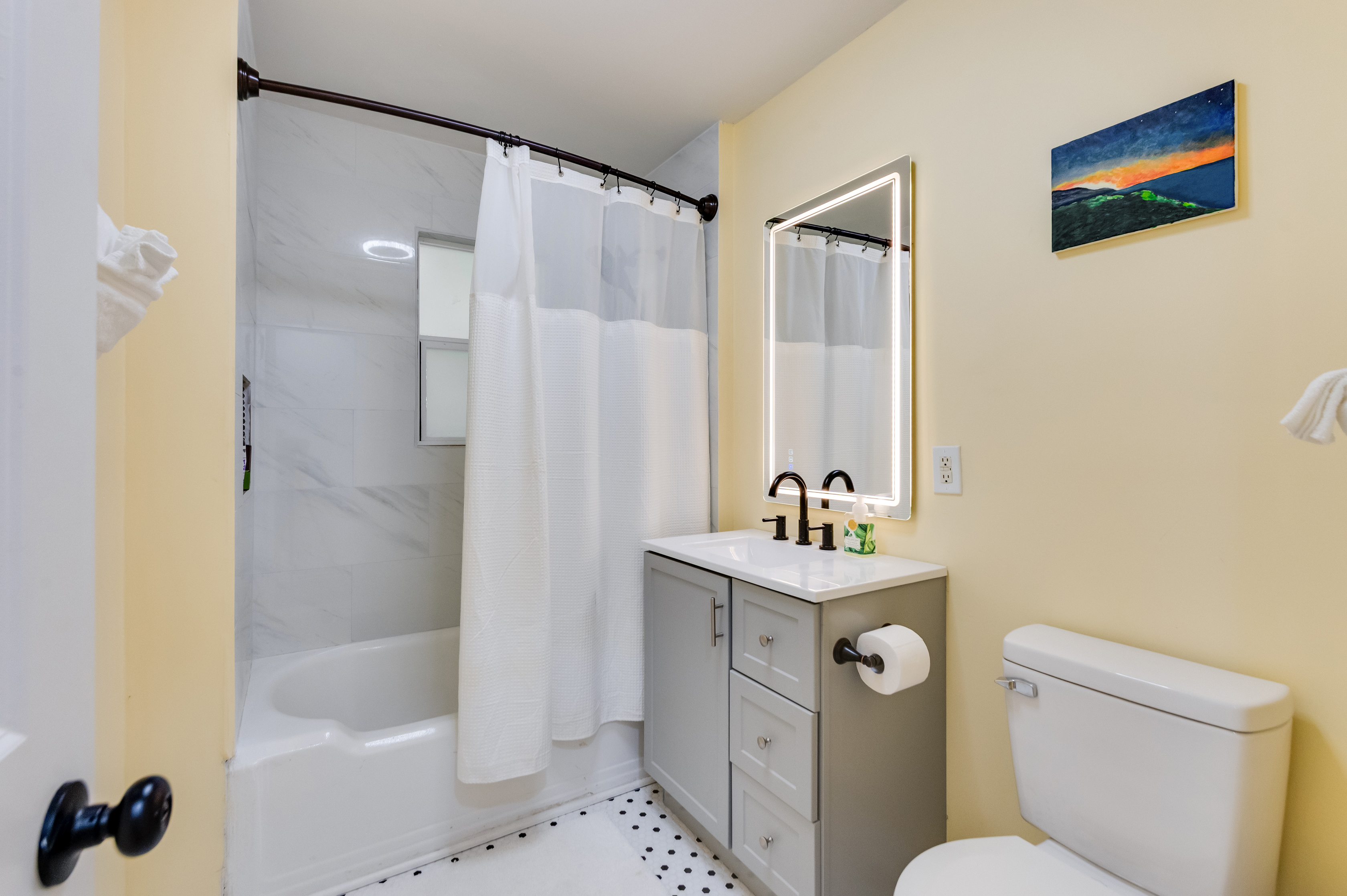Upstairs Full Bathroom 1: Enjoy modern fixtures and vibrant decor for your refreshing getaway!
