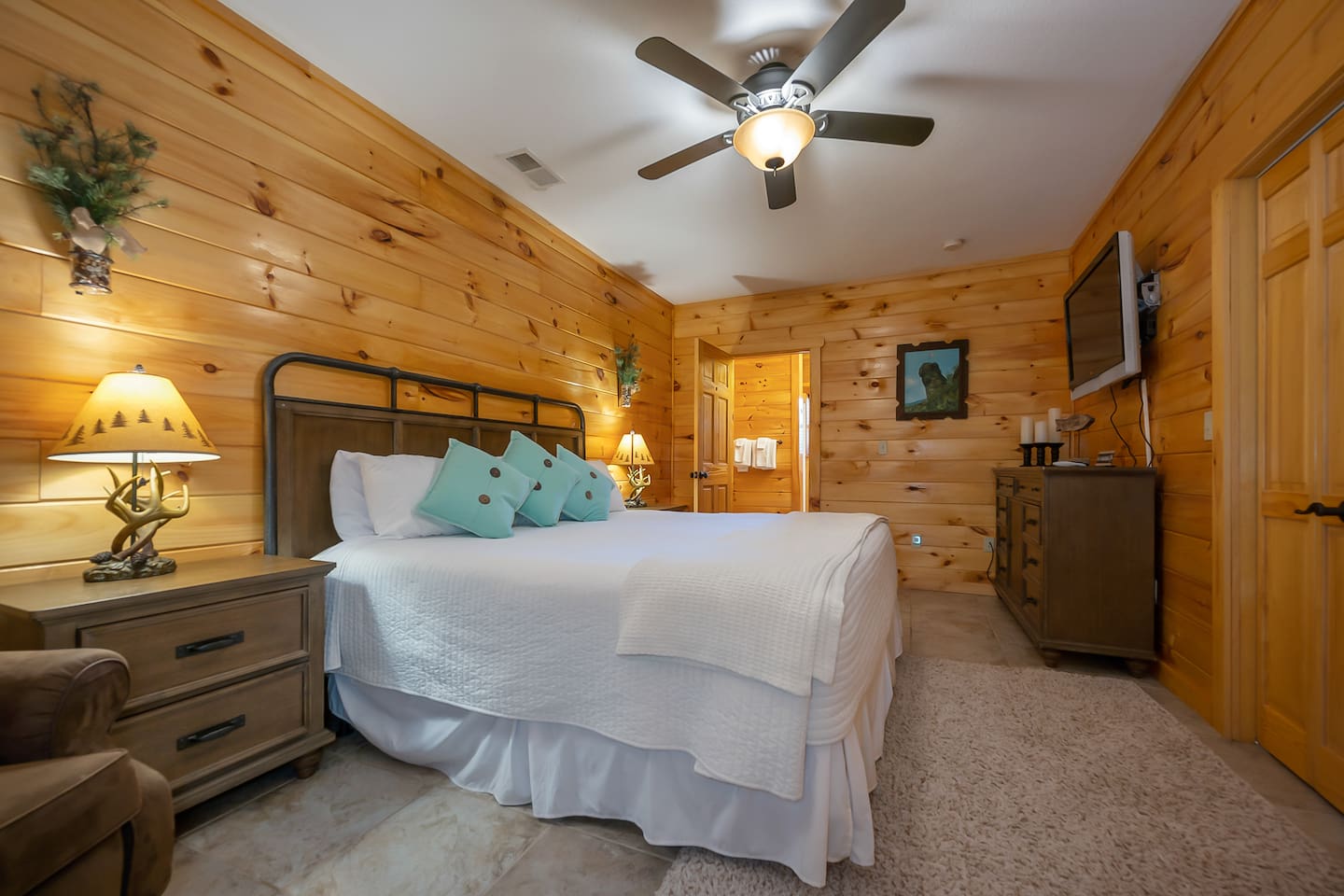 3rd bedroom located in lower level of cabin with king bed and full bathroom