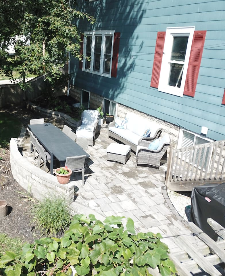 Dining and sitting area and gas grill in private, fenced yard.