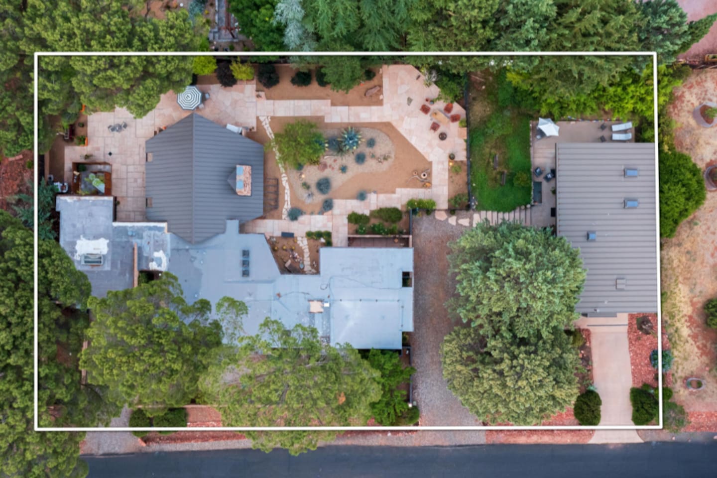 Full-property aerial highlighting the distinctive mid-century footprint, private courtyard, and thoughtfully designed outdoor living spaces.