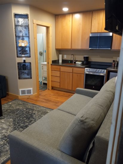 View of living room & kitchen area from unit entrance.