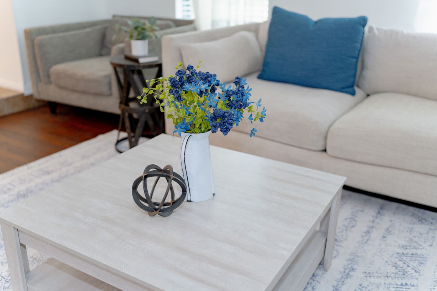 Modern coffee table styling with chic accents and bright flowers.