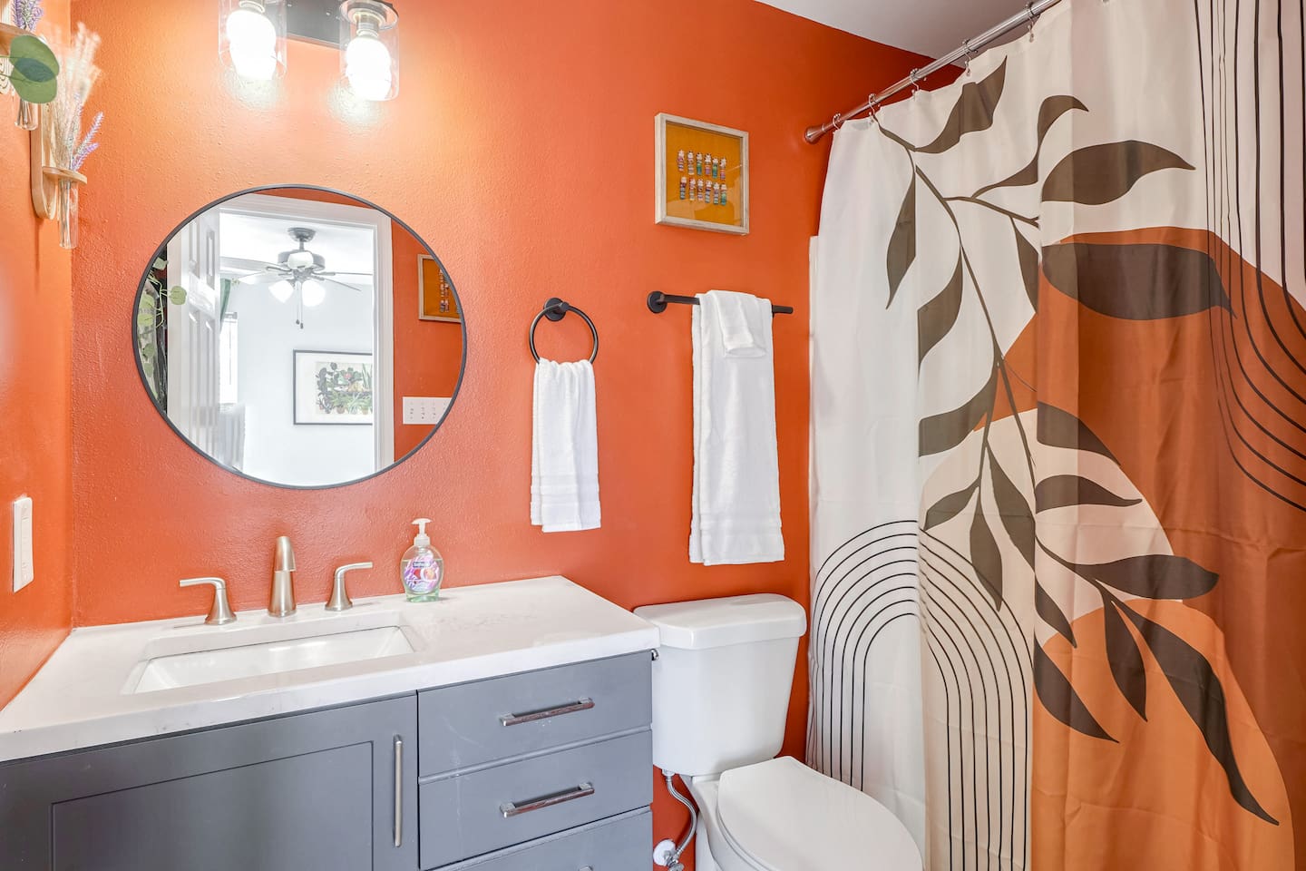 Upstairs master bathroom with modern fixtures, bold decor, and all the essentials for your stay