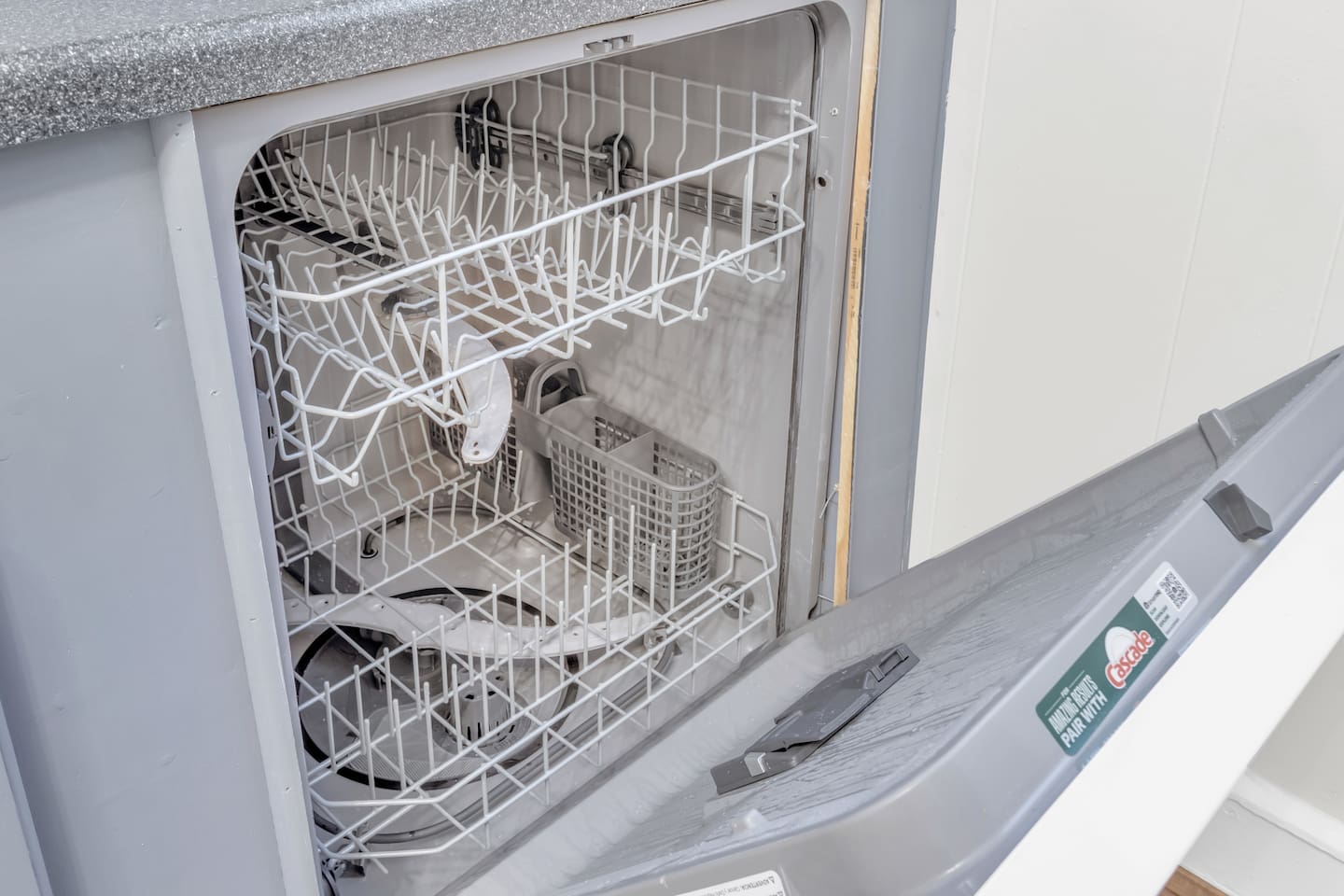 Dishwasher with clean interior for guest use.