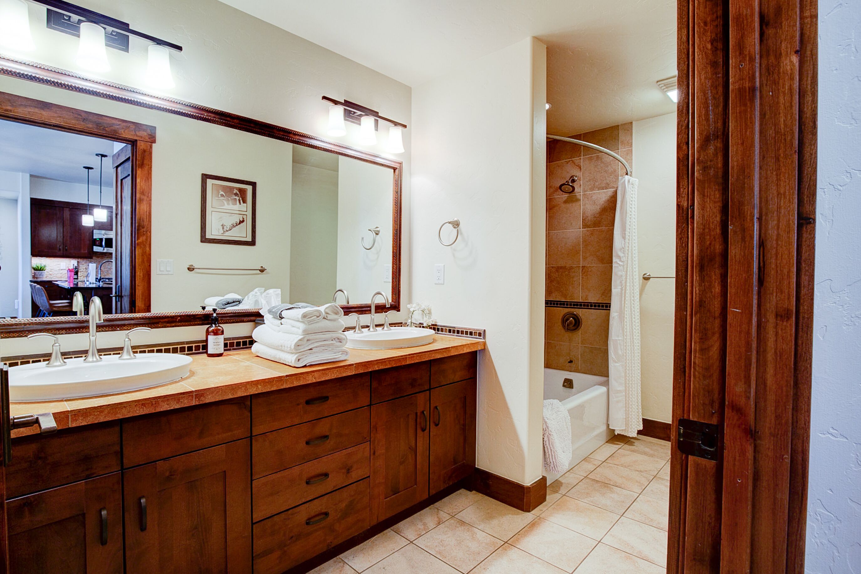 Large guest bath with double sinks and shower/tub combo.