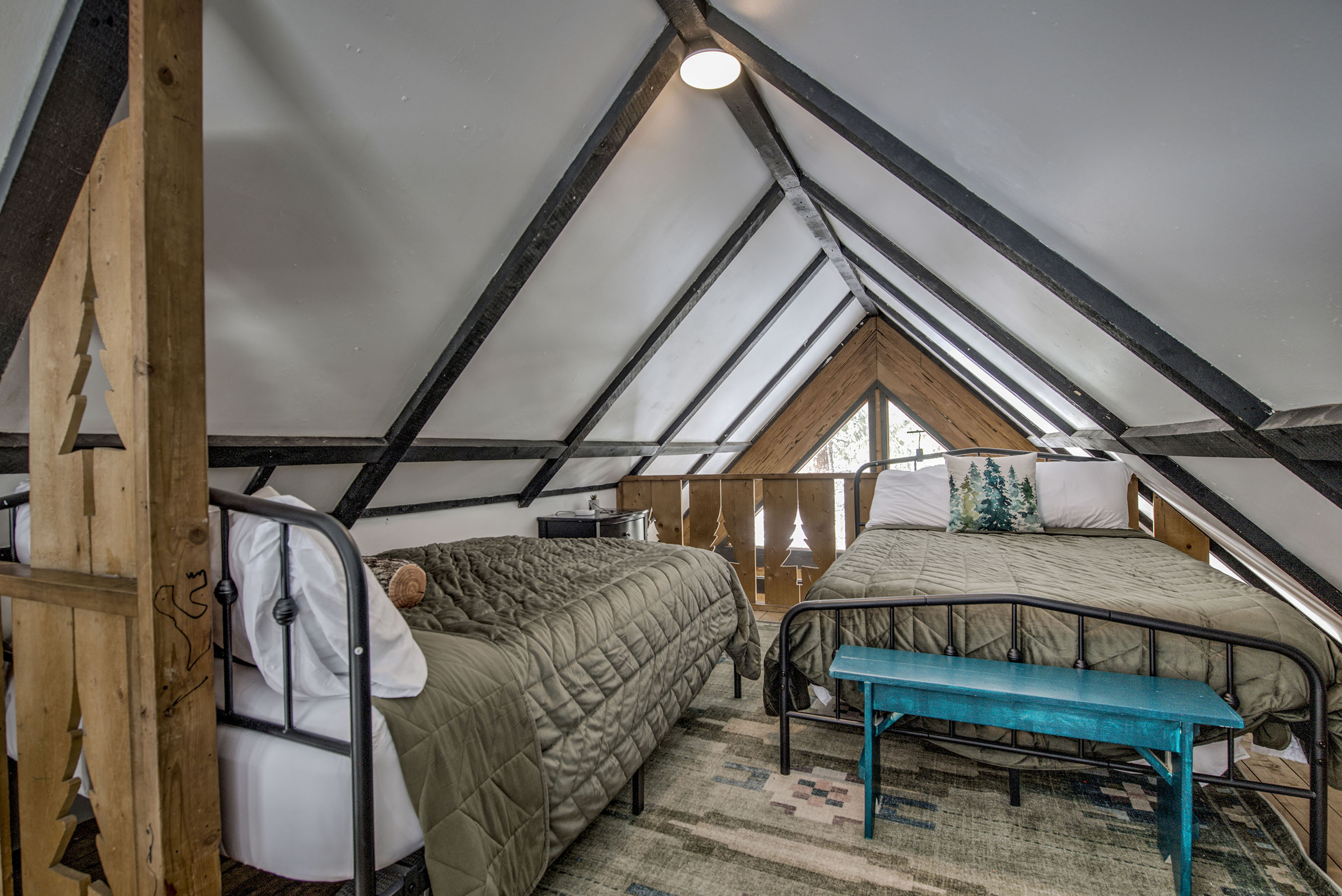 Sleep under the peaks in your cozy loft—twin beds, rustic beams, and a snug space designed for you and yours to rest and recharge.