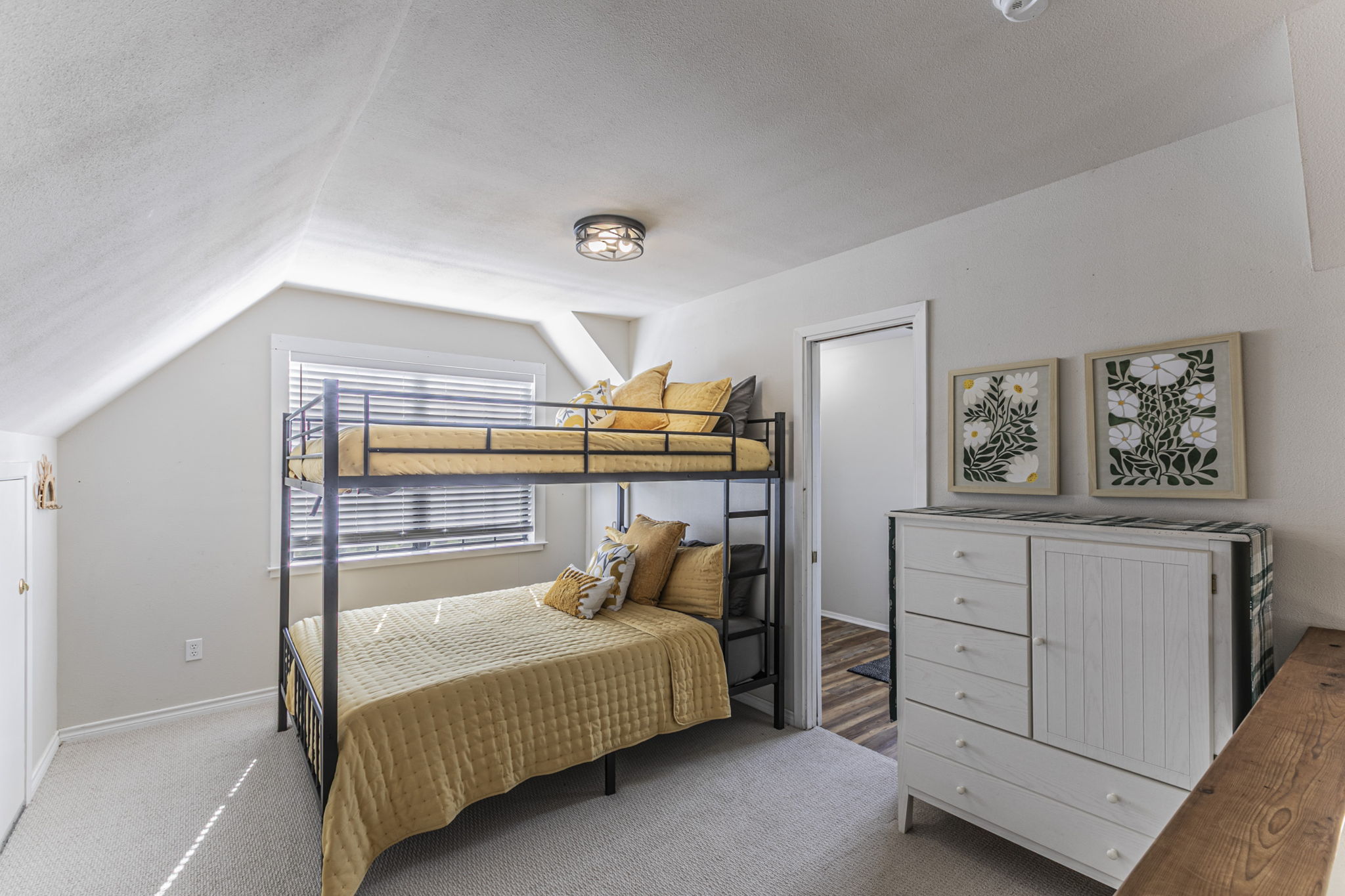 Upstairs open loft bedroom with queen bunk beds and full bathroom.