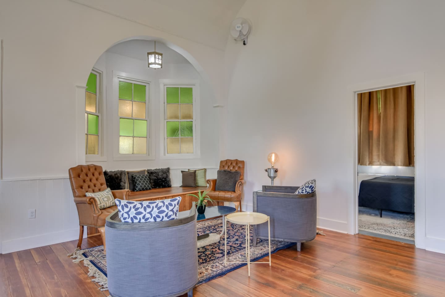 Vintage lounge with patterned rug and original wood trim.