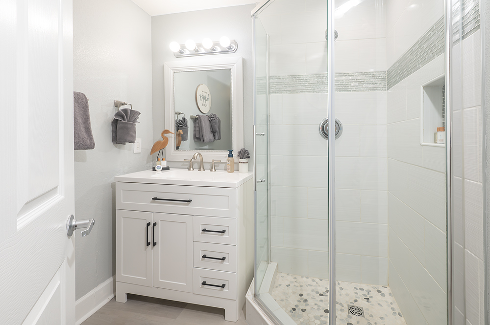Updated coastal hall bath with walk in shower