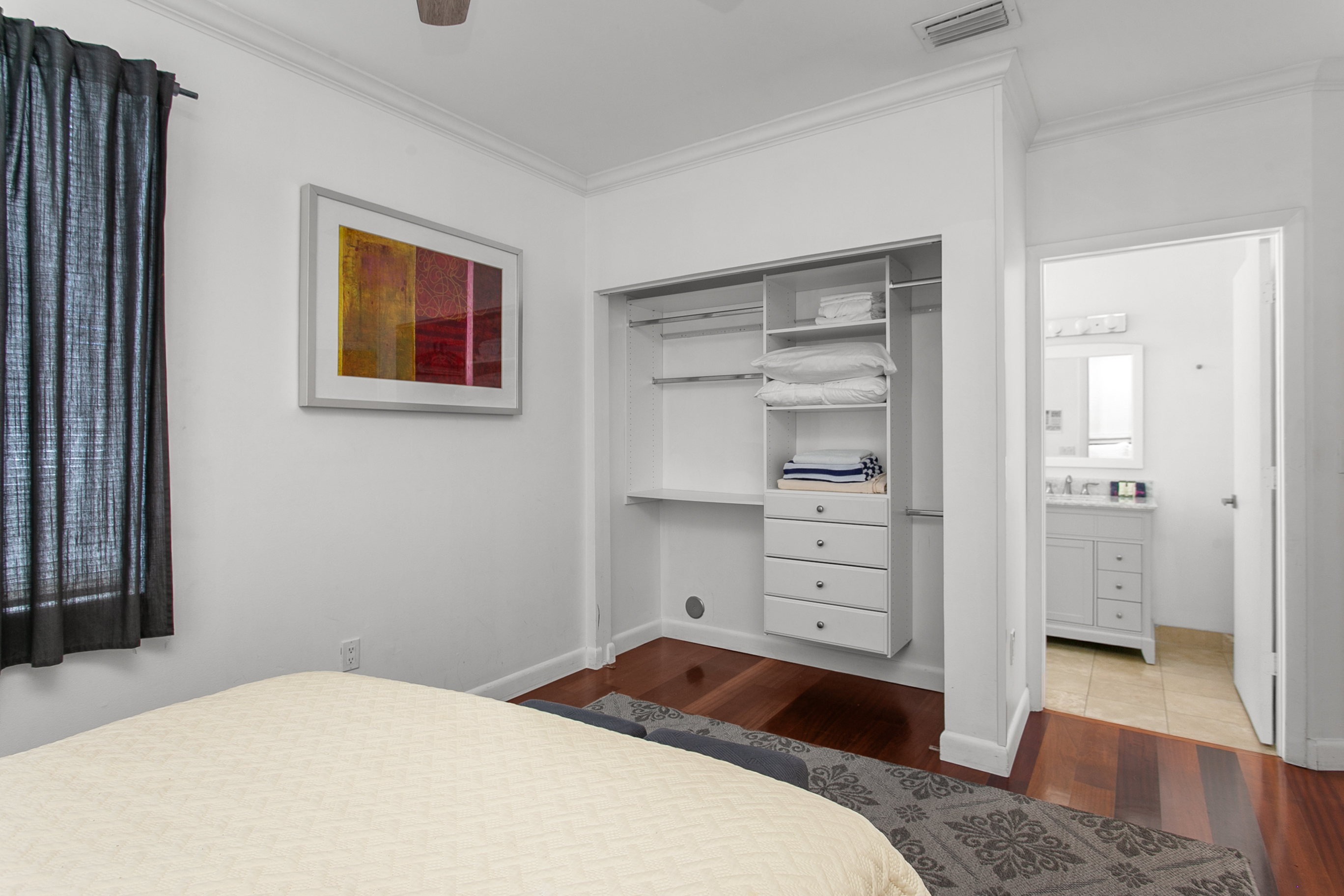 Guest Suite with en-suite bath, closet storage, and room-darkening curtains