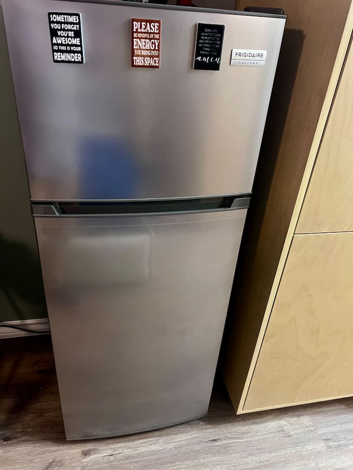 Full-size refrigerator in the kitchenette for storing snacks, drinks, and simple meals.

