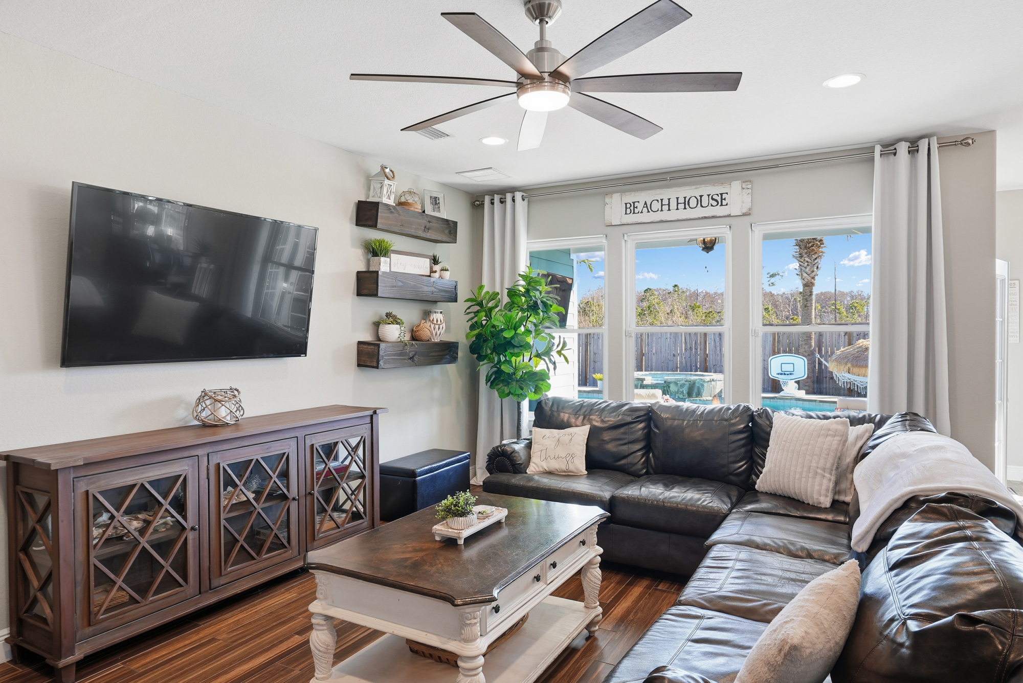 Spacious living room with easy flow to the kitchen, dining area and outdoor amenities.