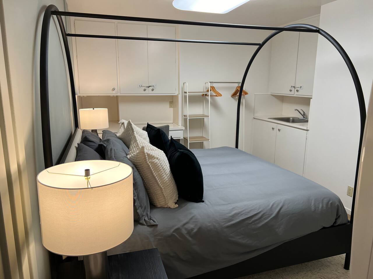 This bedroom has a private coffee bar with a sink, personal coffee maker, and mugs. There is also a desk and chair for your use.