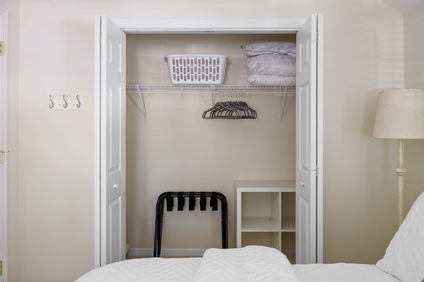 Ample storage space with luggage racks, hangers, laundry basket and extra pillows. 