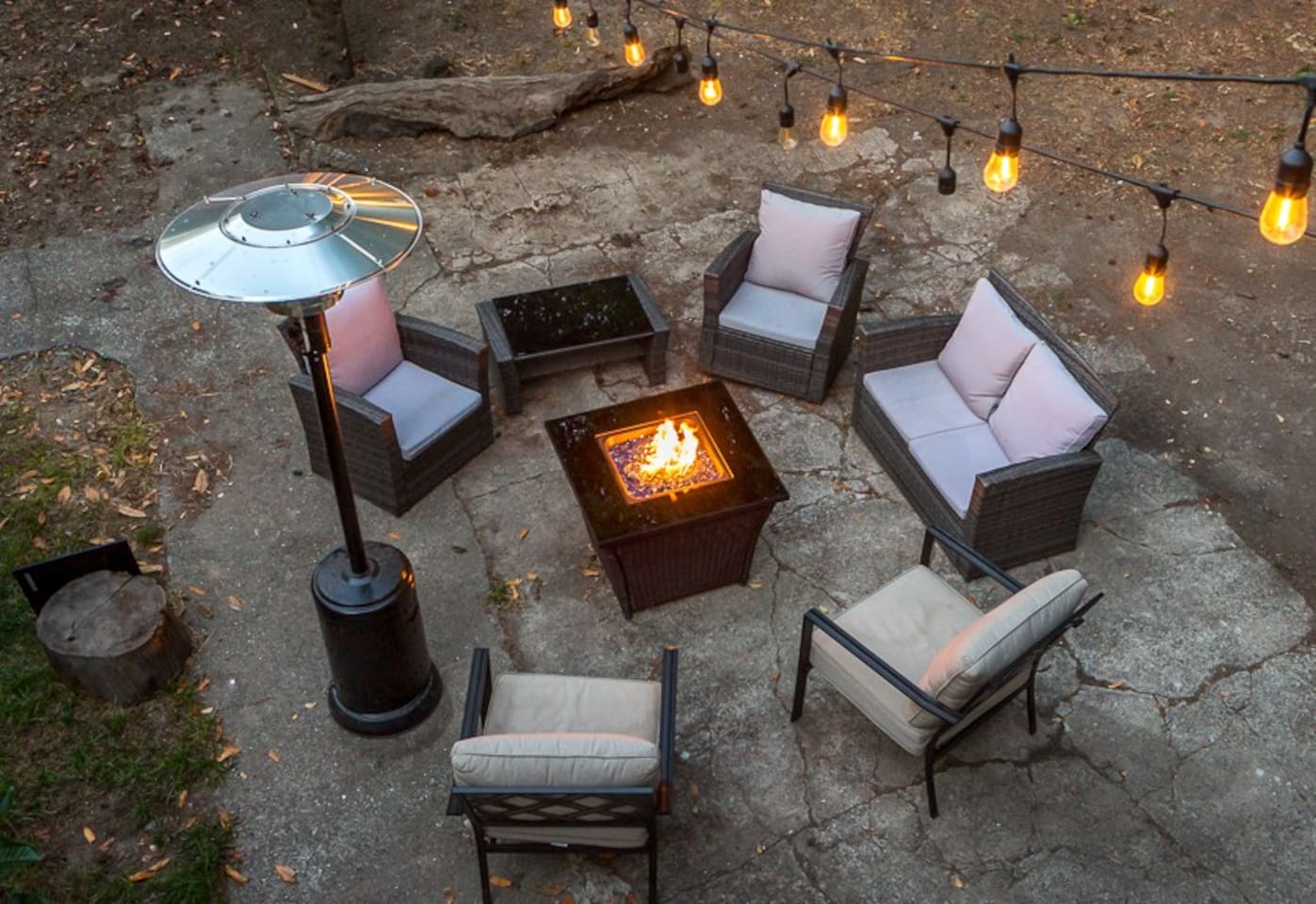 - Inviting fire pit area with cushioned seating for six guests  
- Overhead string lights and patio heater create cozy evenings  
- Perfect for gathering, storytelling, and stargazing together  