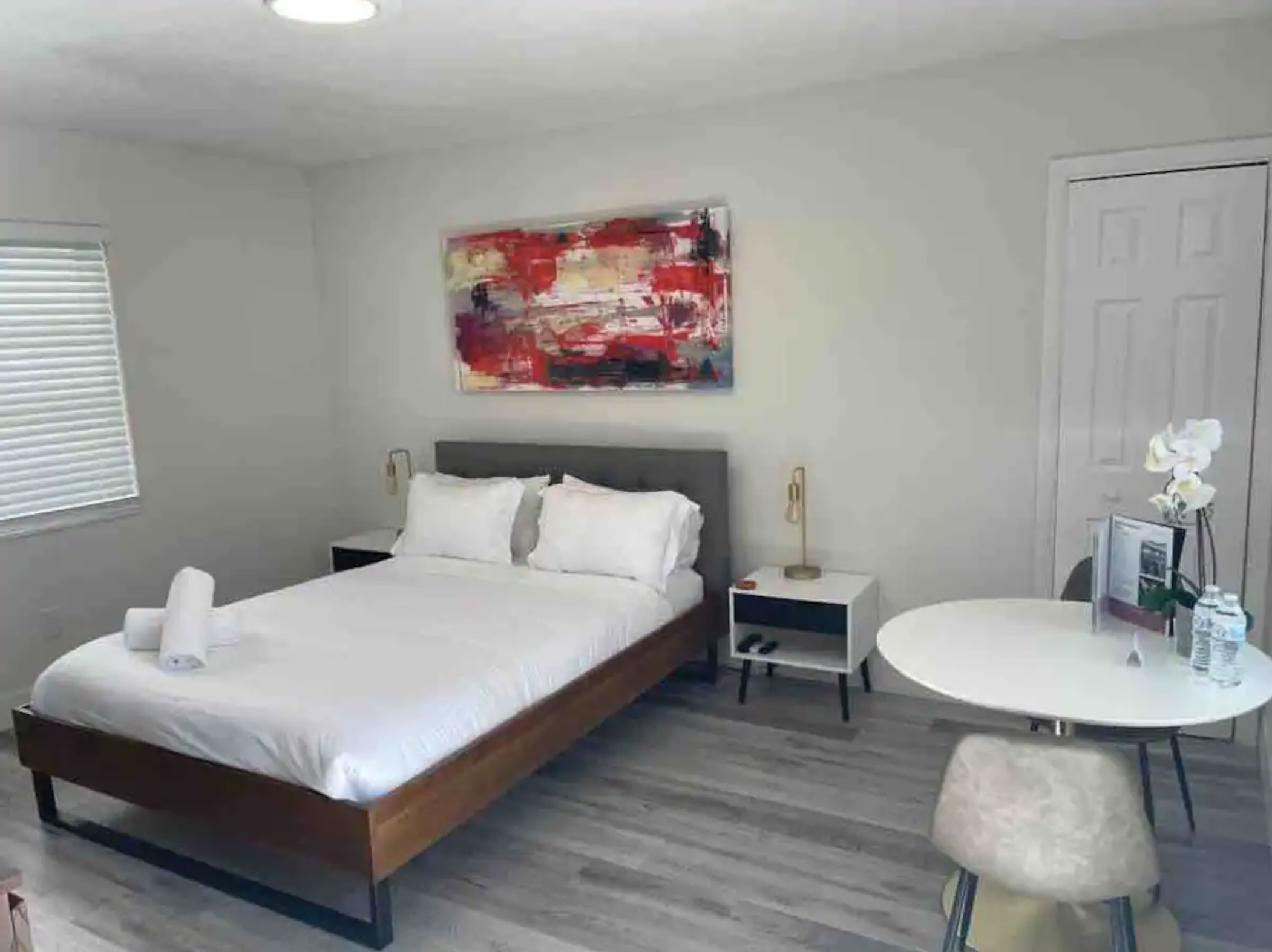 View of queen bed. 40" flat screen smart TV faces bed on opposite wall..