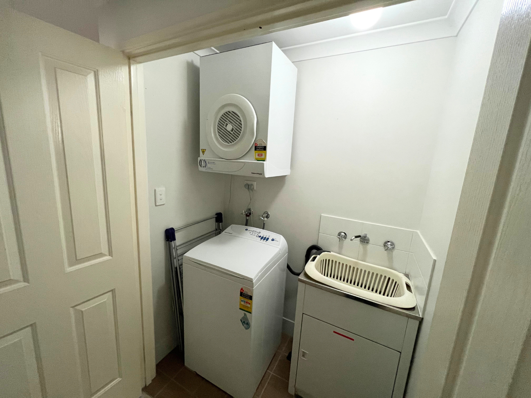 European laundry with top load washing machine and clothes dryer