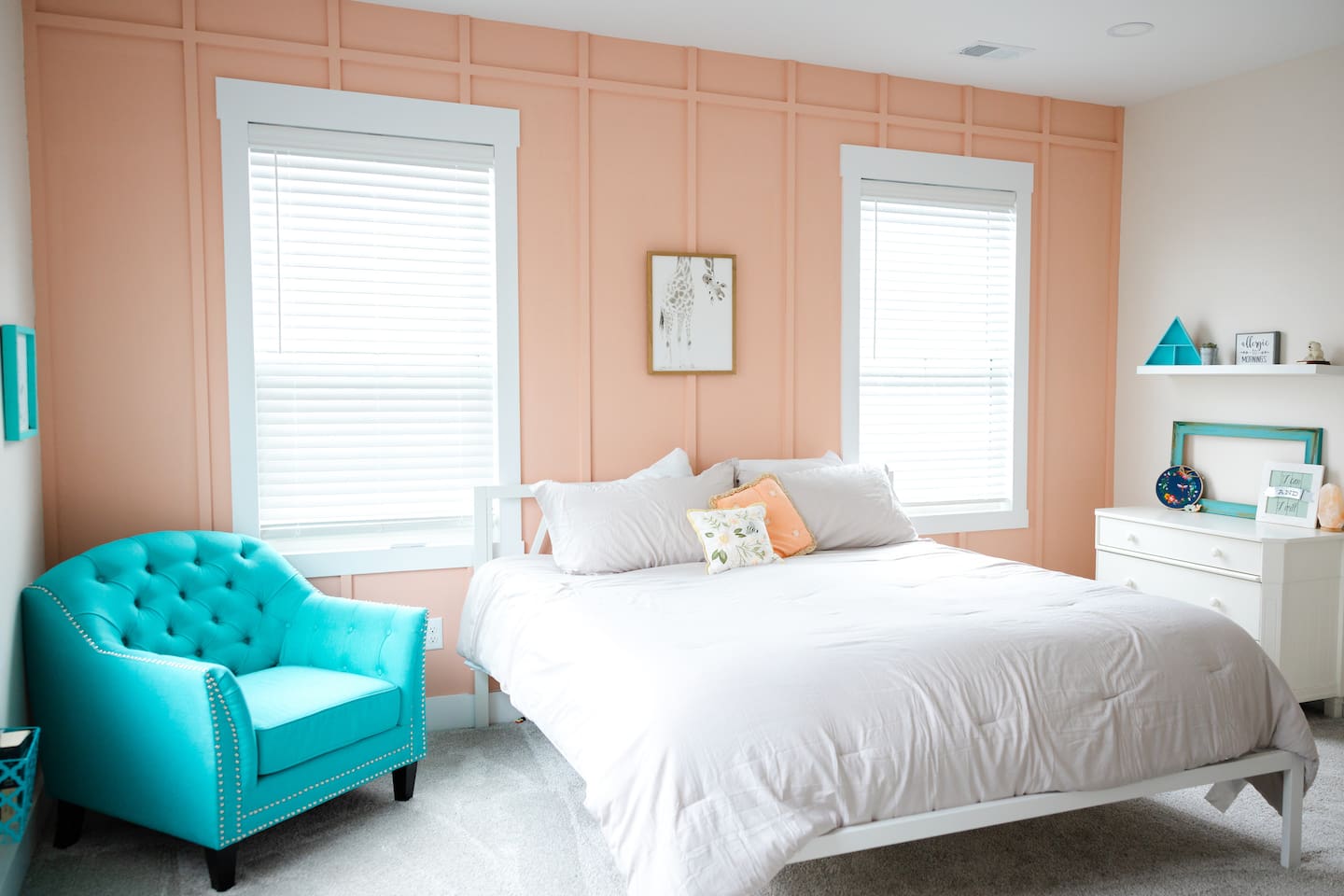 Bright and cheerful, with a super comfy chair for reading and a desk. Private sink and makeup vanity area with access to private toilet and shower rooms, which are shared with bedroom #5. 