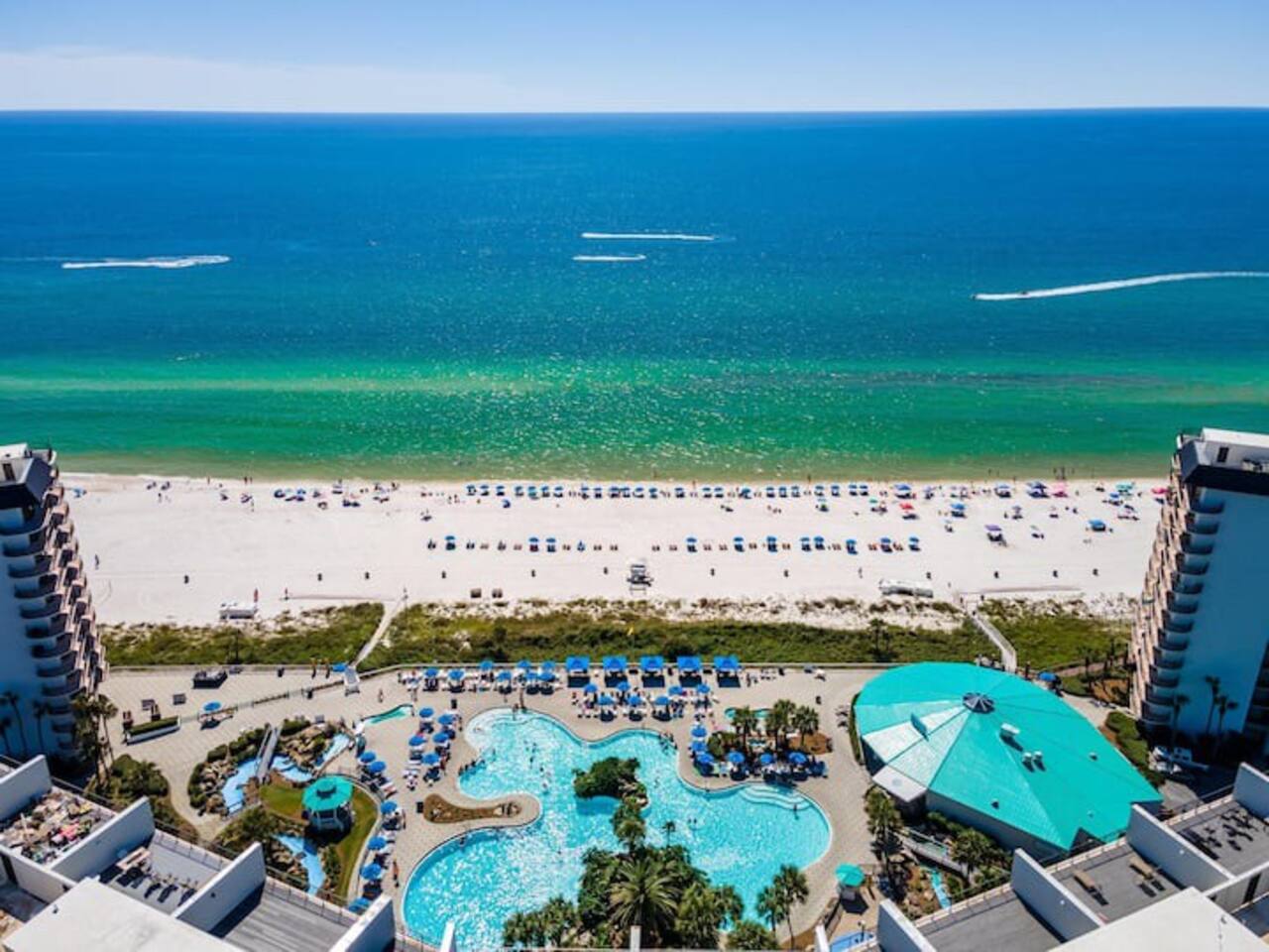 Aerial shot of the lagoon pool, splash pad  and the restaurant (blue roof)