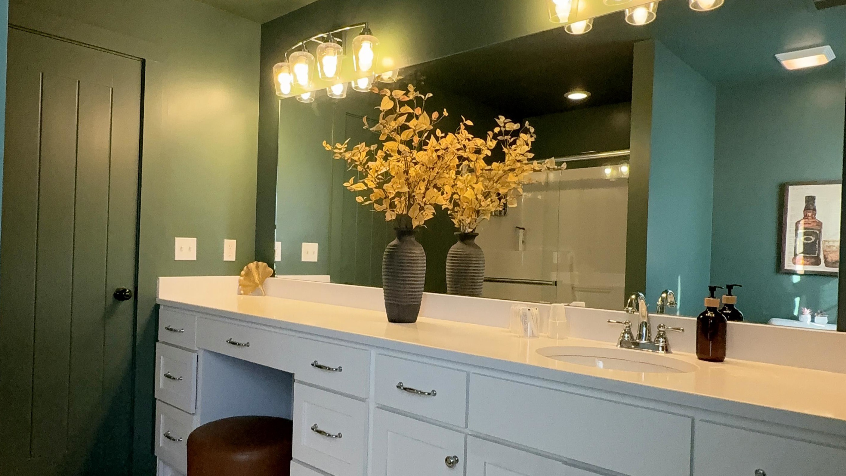 Every detail tells a quiet story of care — from the tailored lighting and deep green tones to the spacious vanity designed for both reflection and ease. A private sanctuary where daily rituals unfold with intention, calm, and understated luxury.