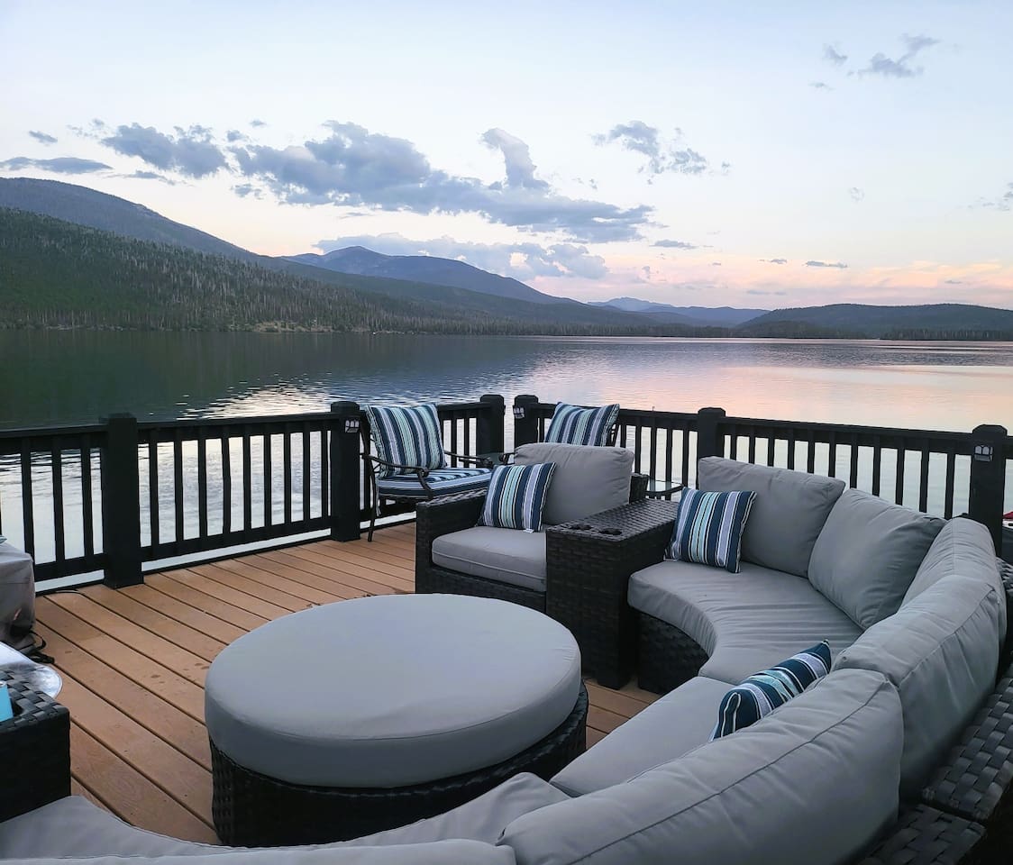 Boathouse deck on the water offers views like no other house on the lake! Circular 10 person seating with firepit table and 8 person dining table makes this place another great gathering spot!