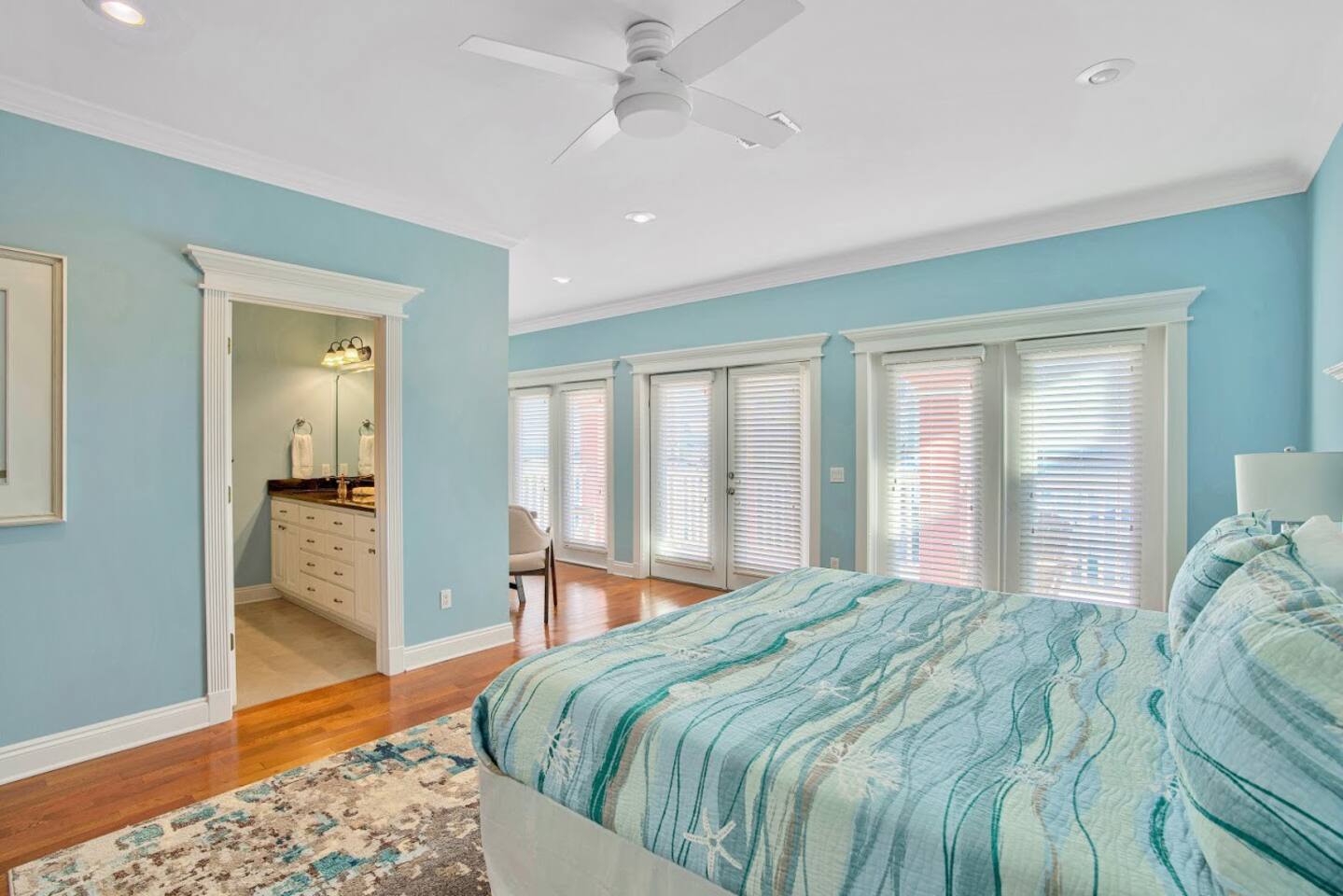 Master bedroom with king size bed, private bathroom, private kitchenette, reading/sitting area and private 3rd floor porch through center door.