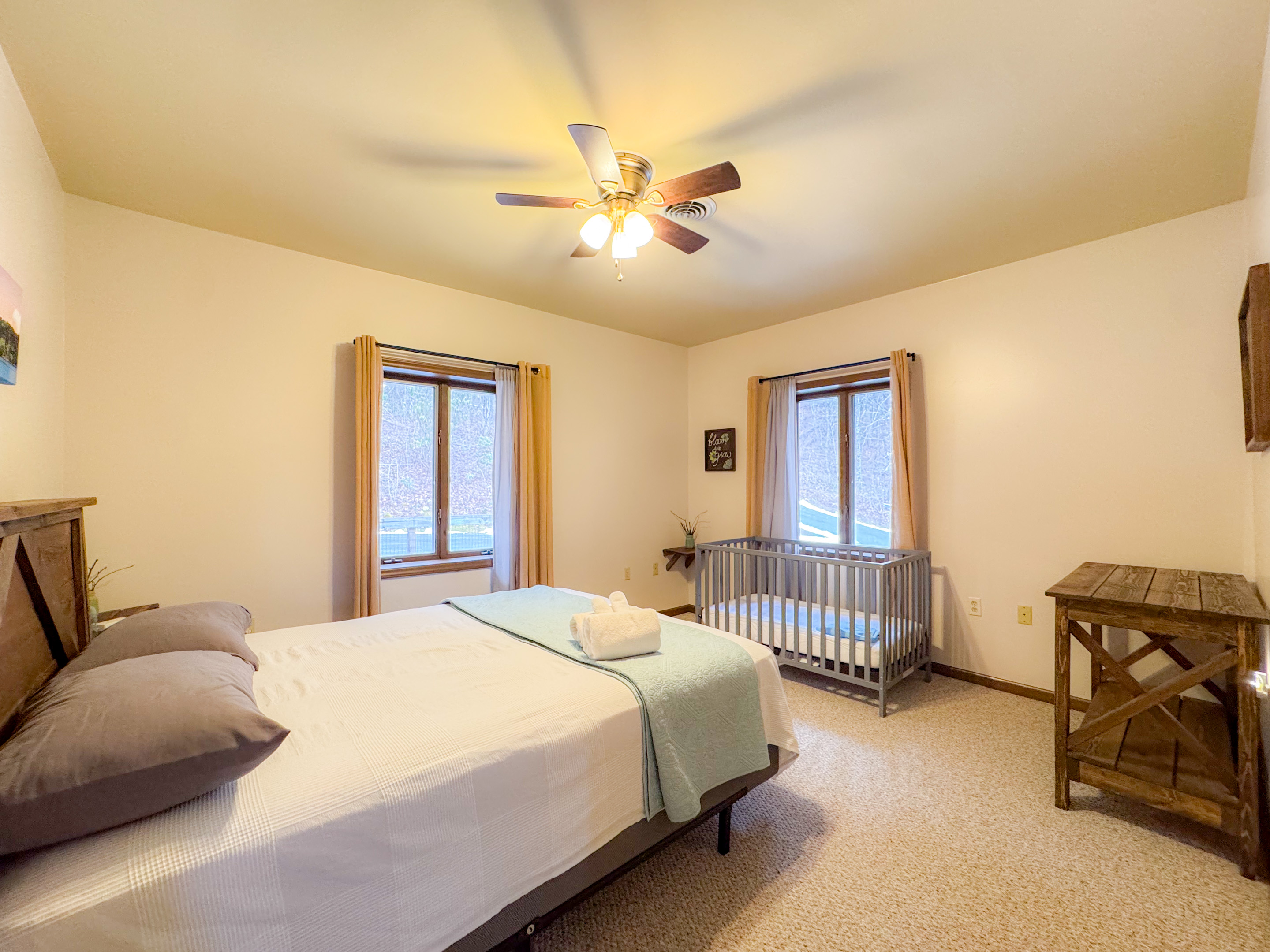 The scenic drives themed bedroom is setup for those with an infant. Complete with room darkening curtains, a crib and a changing table.