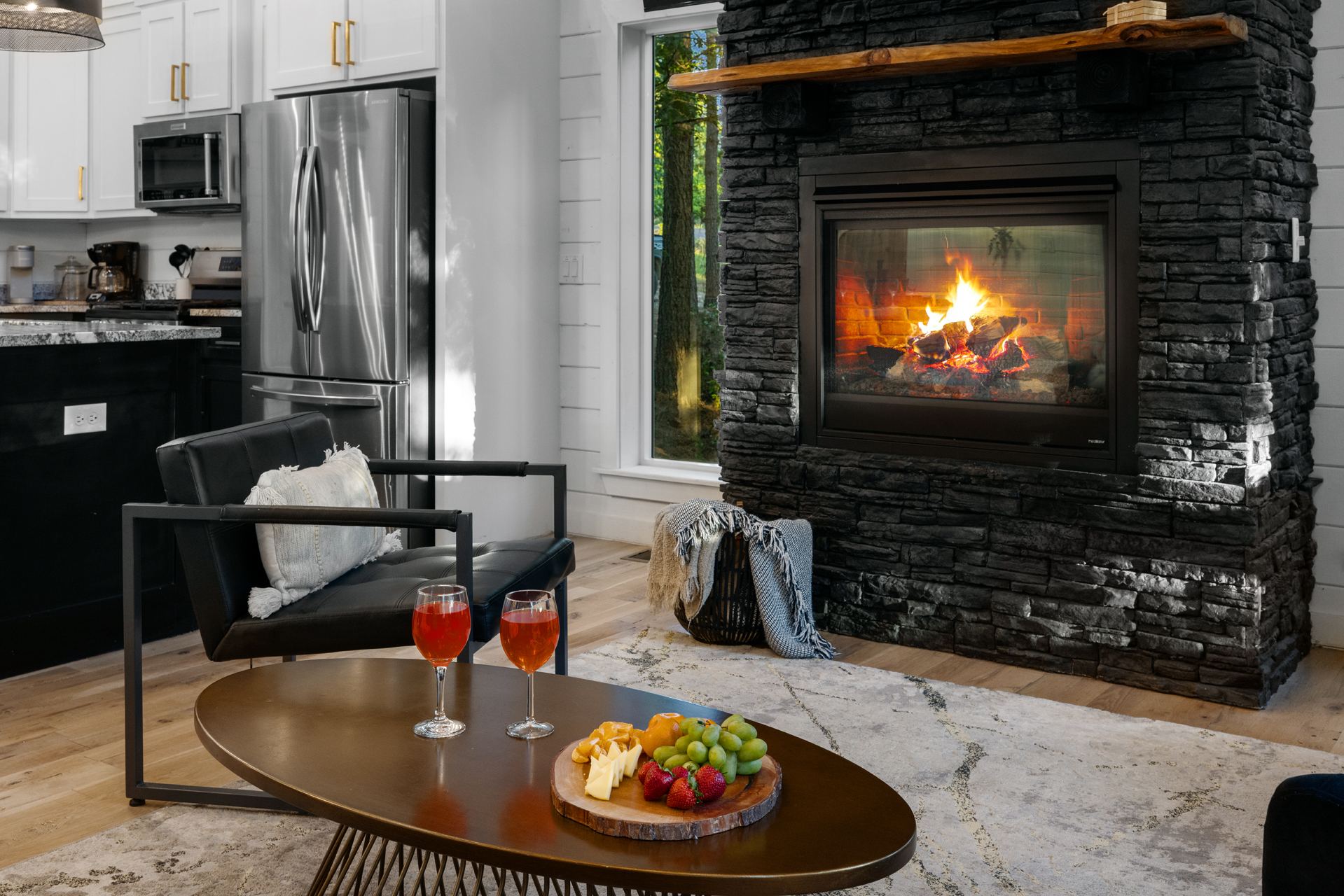 Relaxed indoor space built for connection, with cozy furnishings and a warm fireplace glow.