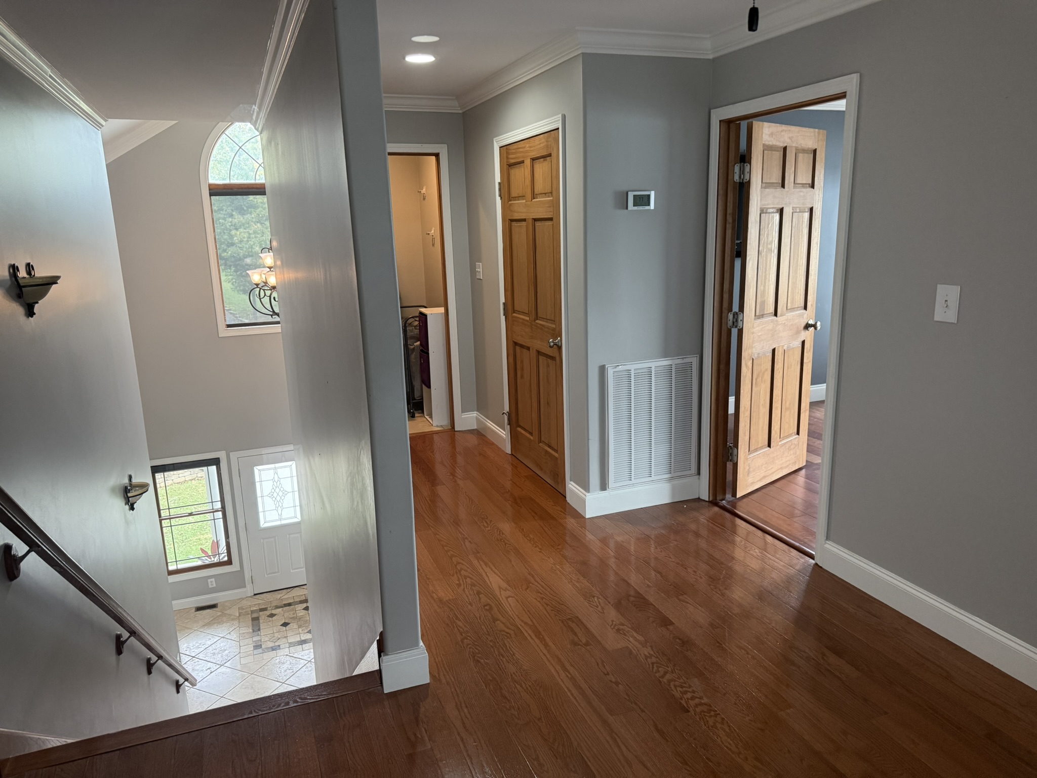 Upstairs hallway with a view into laundry room, linen closet and Bedroom 1