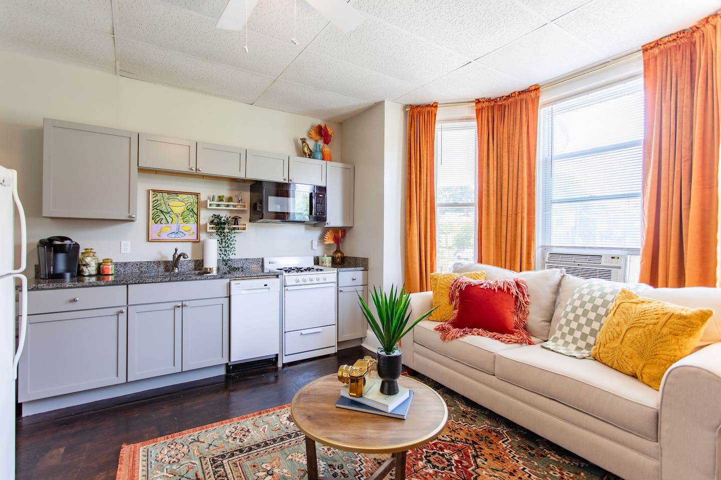 Open living area with the kitchen conveniently located on the side, creating a spacious and functional layout for both relaxation and meal preparation.