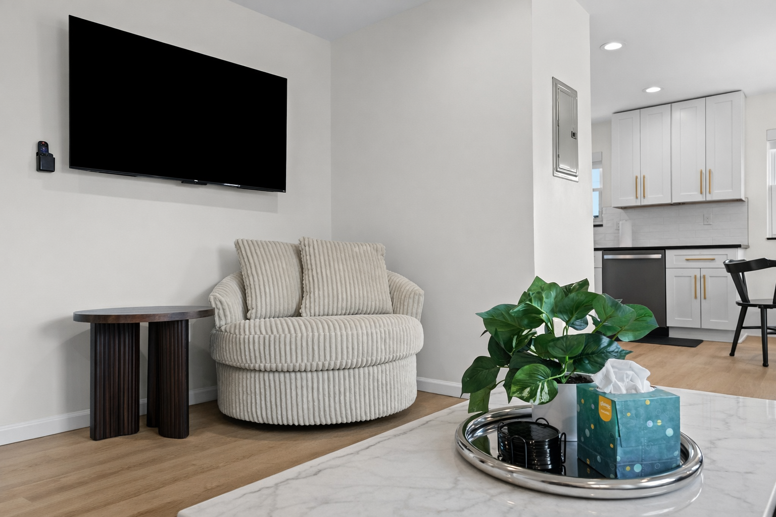 Cozy lounge nook with plush seating, large smart TV, and stylish accents—perfect for unwinding, movie nights, or enjoying a quiet moment indoors.