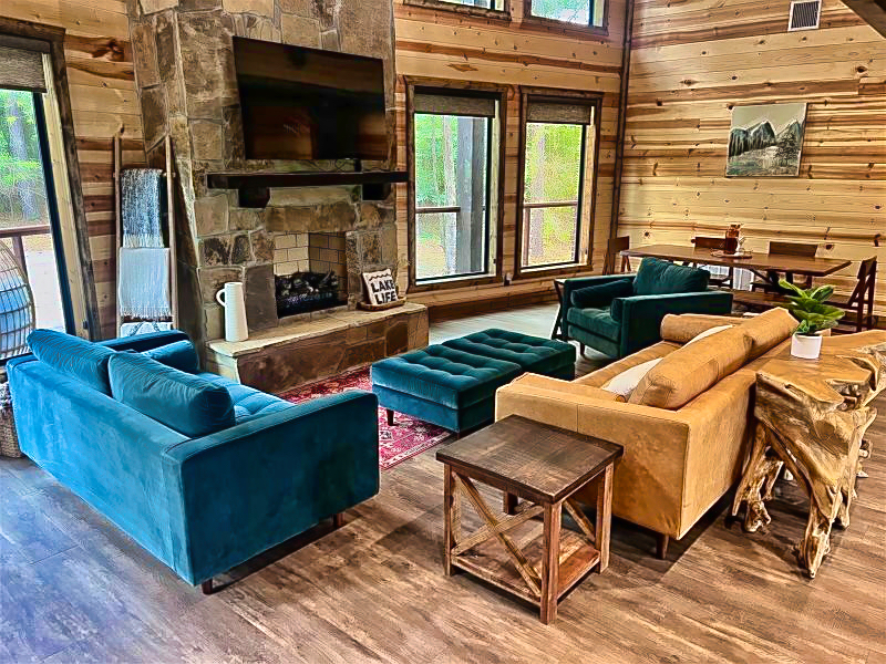 Soaring windows frame the pond outside while warm wood and stone invite you to gather and relax.