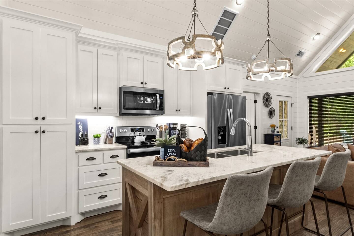 Granite counters offer both beauty and durability, making meal prep a breeze in this bright, open kitchen space.